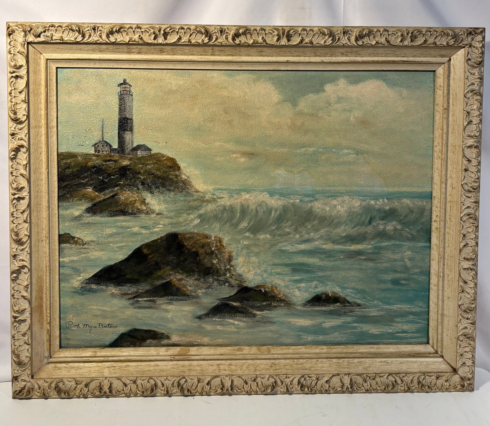 Midwestern Wisconsin Artist Ruth Myre, Signed Highland Shores Oil on Canvas: A vintage oil-on-canvas seascape by Wisconsin artist Ruth Myre, depicting a lighthouse rising above a rocky shoreline as waves break across the foreground beneath a cloud-filled sky. Rendered in soft 