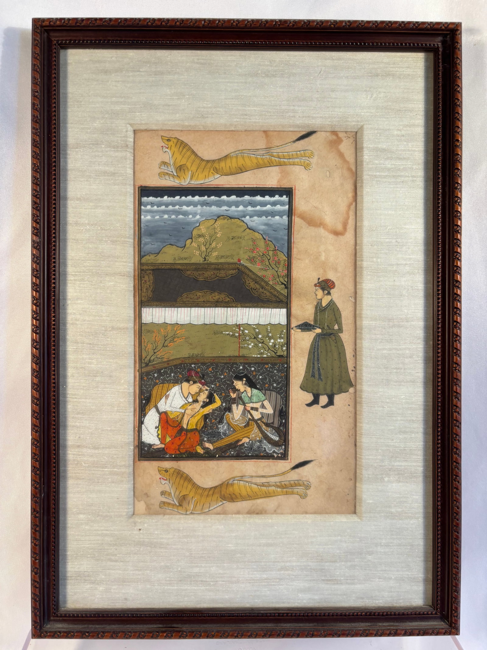 Indian Mughal Style Miniature Painting, Courtly Lovers & Tigers, Custom Framed: This captivating vintage Indian miniature painting depicts a romantic Mughal court scene, showcasing a nobleman and consort embracing on a terrace while a court attendant stands nearby, beautifully fr