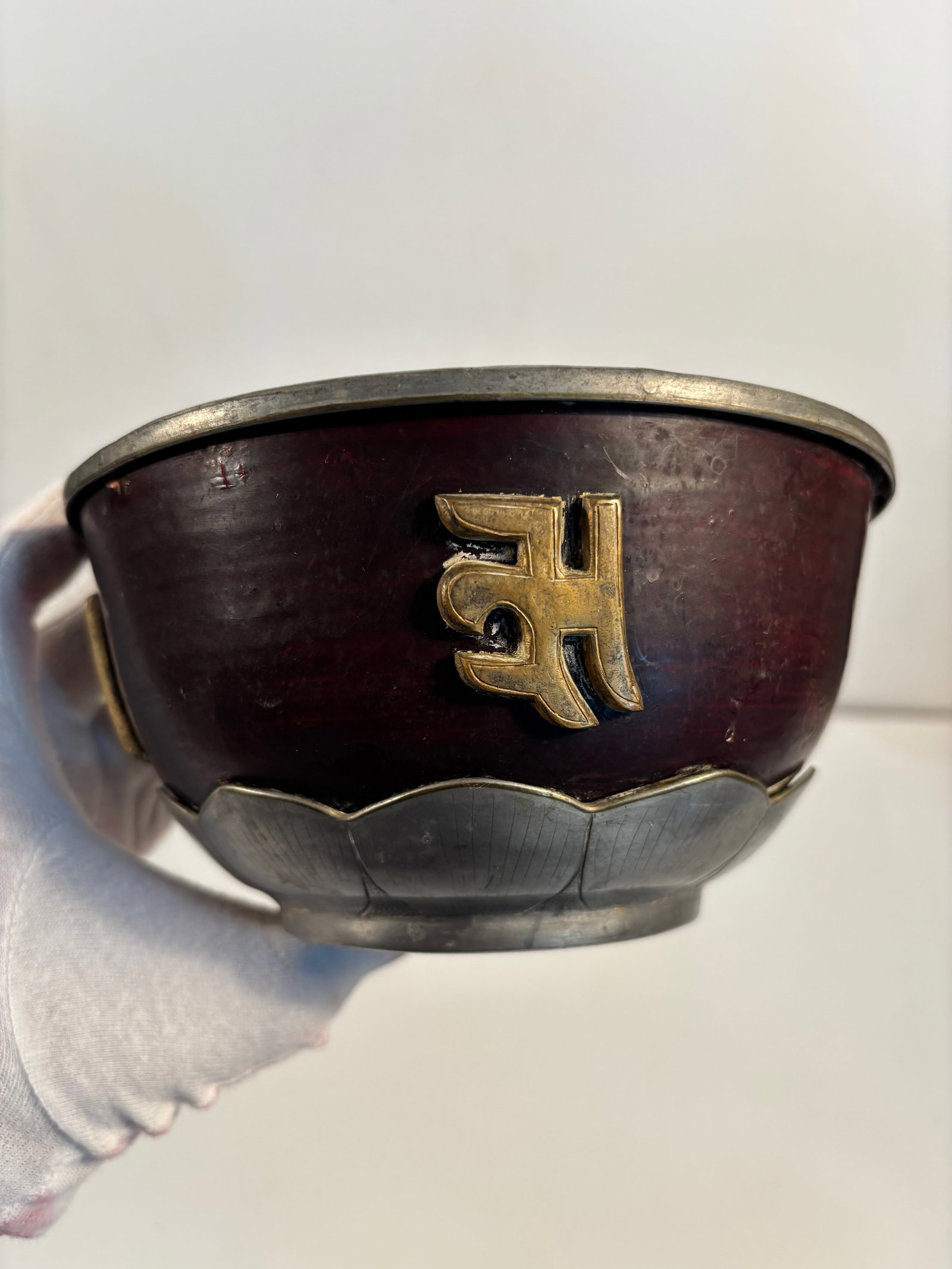 A rare Tibetan or Chinese Gourd-and-pewter ritual bowl with Mongolian mark at bottom: Yuan Dynasty (1271-1368) ; Made from a dried and lacquered gourd, giving it that rich reddish-brown tone and lightness.Inlaid or mounted with cast pewter, shaped like lotus petals around the base — 