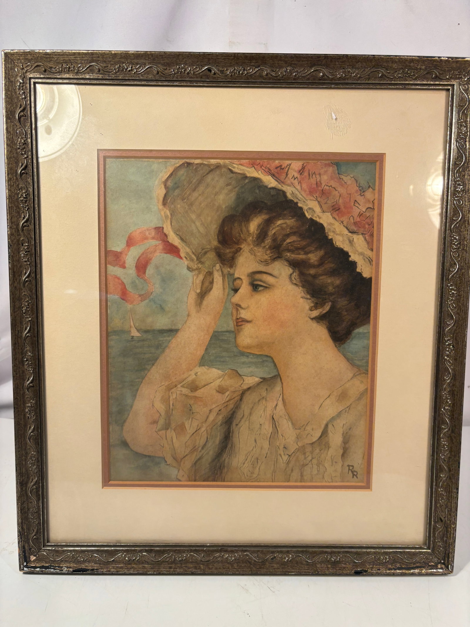 Watercolor Portrait of a Lady with Parasol, Signed “RR: Late 19th century , A watercolor on paper depicting an elegant young woman holding a floral parasol beside the sea, with a sailboat visible in the distance. Rendered in soft pastel tones and signed wi
