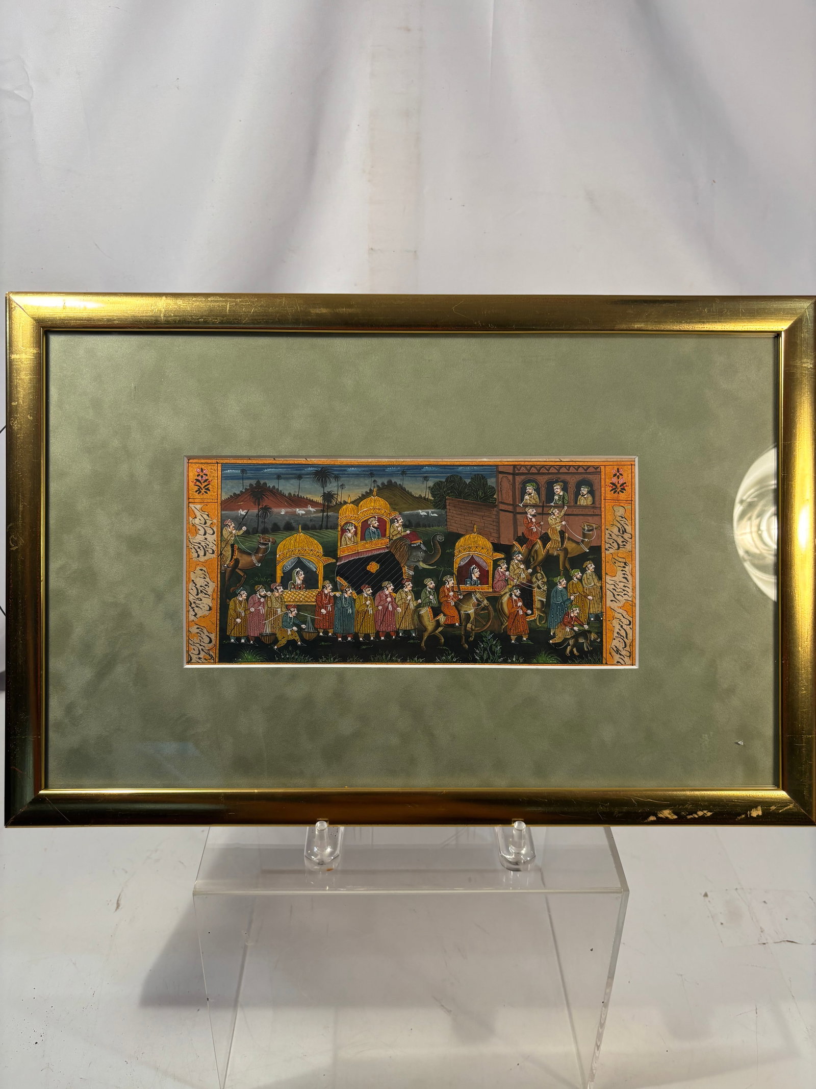 Hand-Painted Indian Rajasthani Miniature of a Royal Wedding Procession: A finely detailed hand-painted Rajasthani miniature depicting an elaborate royal wedding procession. The lively scene features richly dressed figures, attendants, musicians, horses, camels, a decorate