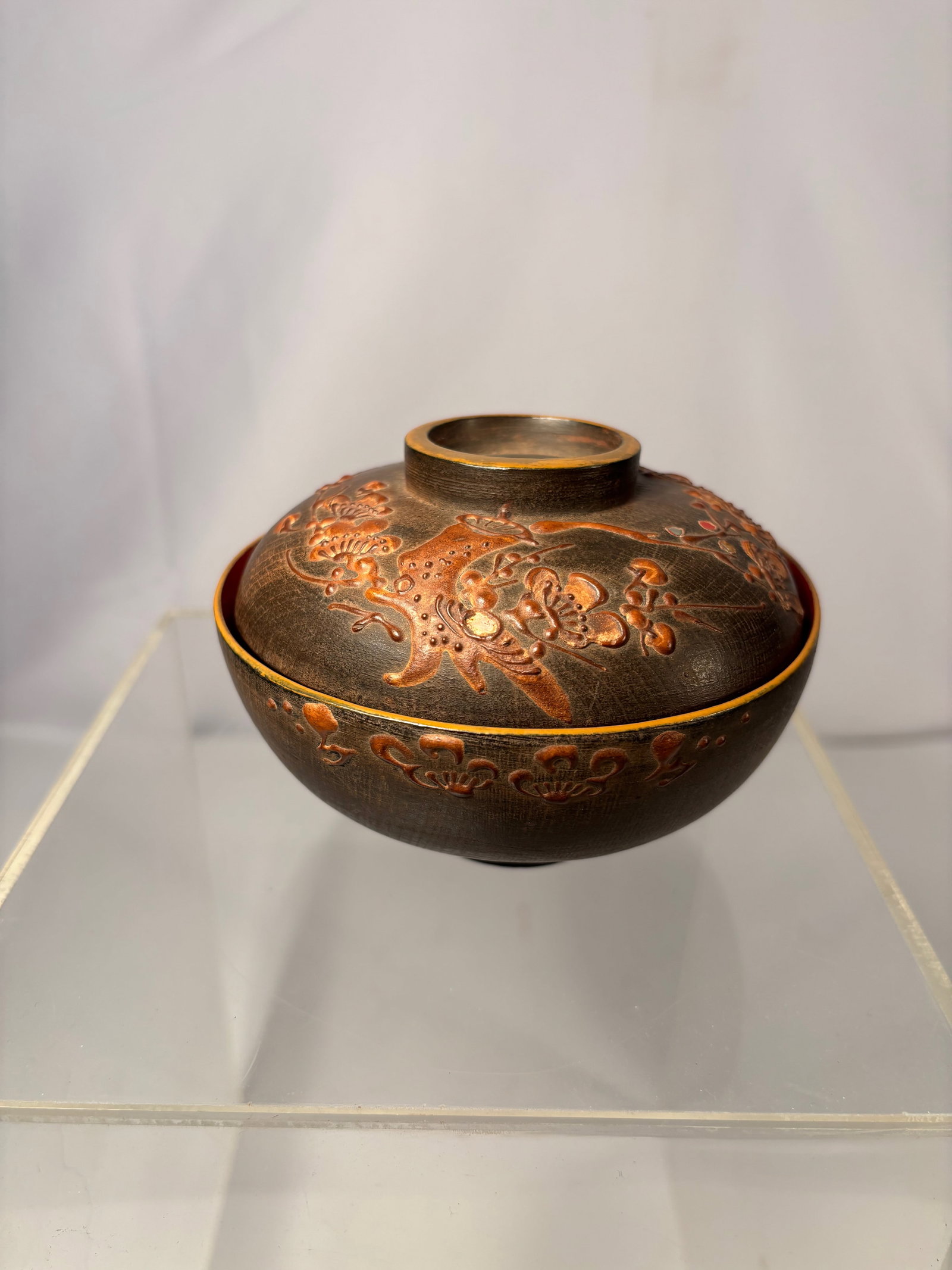 A Japanese Lacquer Covered Bowl with Raised Plum & Bird Decoration, Edo–Meiji Period (1850-1900): The bowl is lathe-turned from wood and notably left largely exposed rather than fully lacquered, an intentional and highly uncommon aesthetic choice.The exterior is decorated with thickly built-up