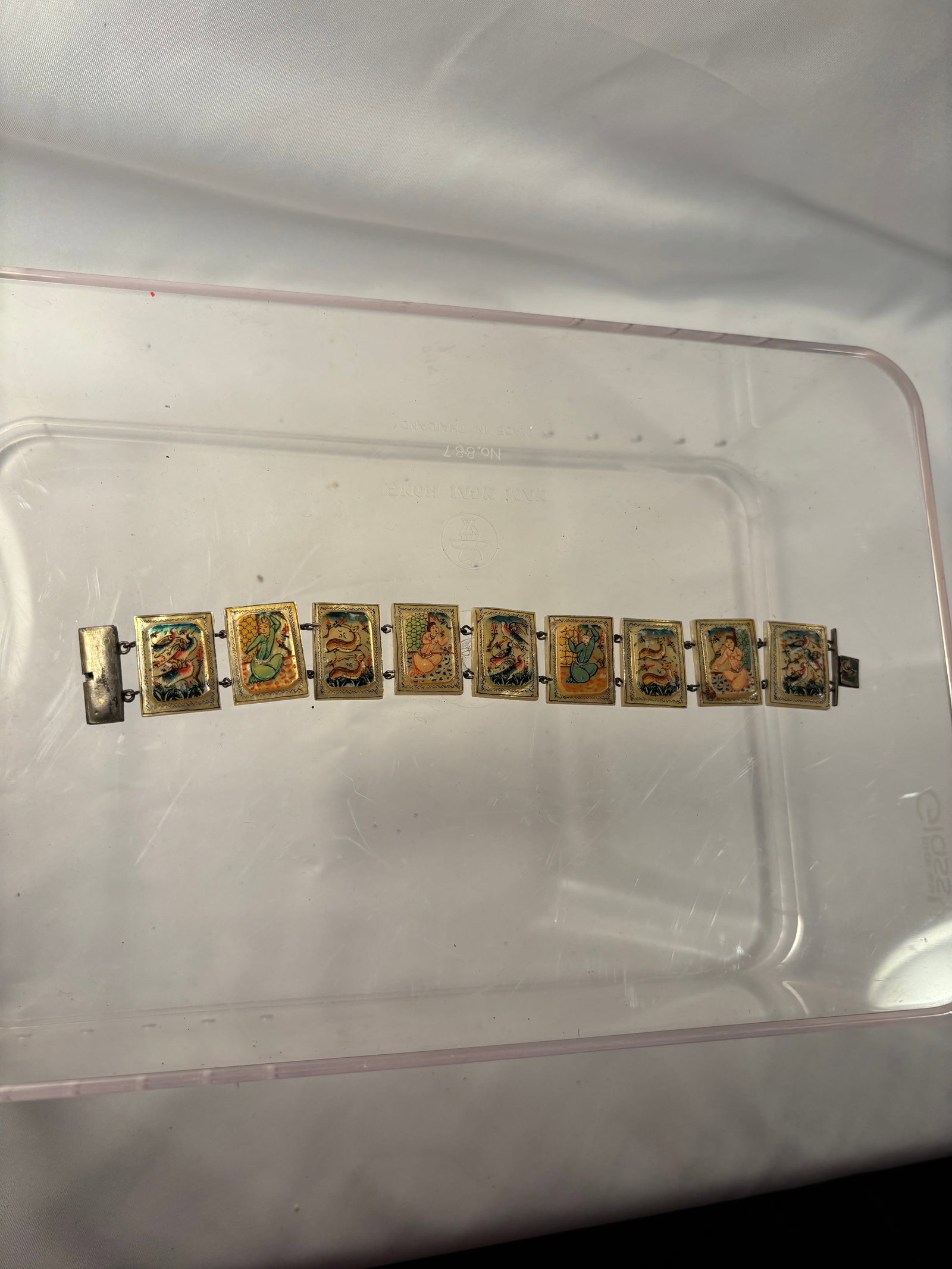 Vintage Persian Hand-Painted Mother-of-Pearl Miniature Panel Bracelet: A vintage Persian articulated bracelet composed of nine rectangular mother-of-pearl panels, each finely hand-painted with colorful narrative scenes depicting courtly figures, birds, deer, and other an