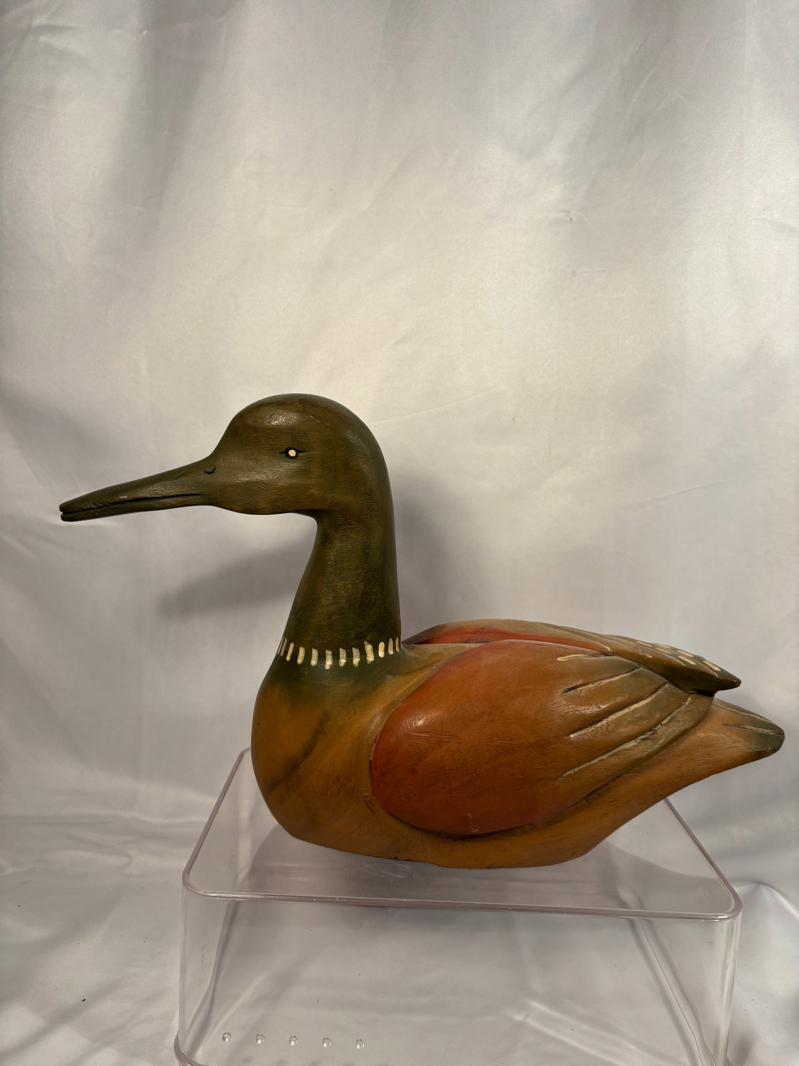 Vintage Hand-Carved and Painted Wooden Waterfowl Decoy: A vintage hand-carved wooden waterfowl decoy featuring a long neck and slender bill, decorated with stylized green, russet, brown, and cream-colored plumage. The underside is painted black. Length: 15
