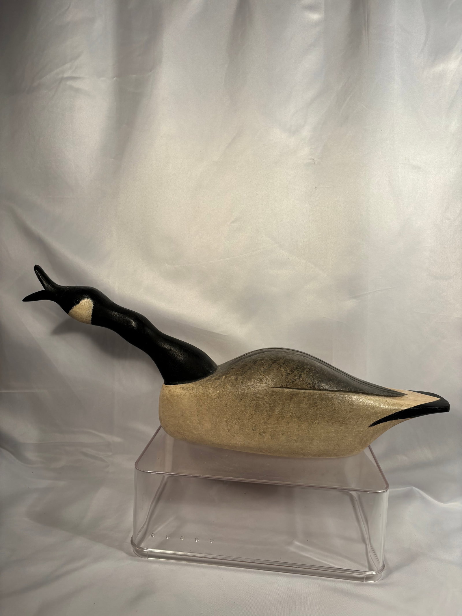 Signed Wooden Canada Goose Decoy in Honking Pose: A vintage hand-carved and hand-painted wooden Canada goose decoy depicted with a raised head and open bill in a distinctive honking pose. Featuring a black head and curved neck with cream-colored chee