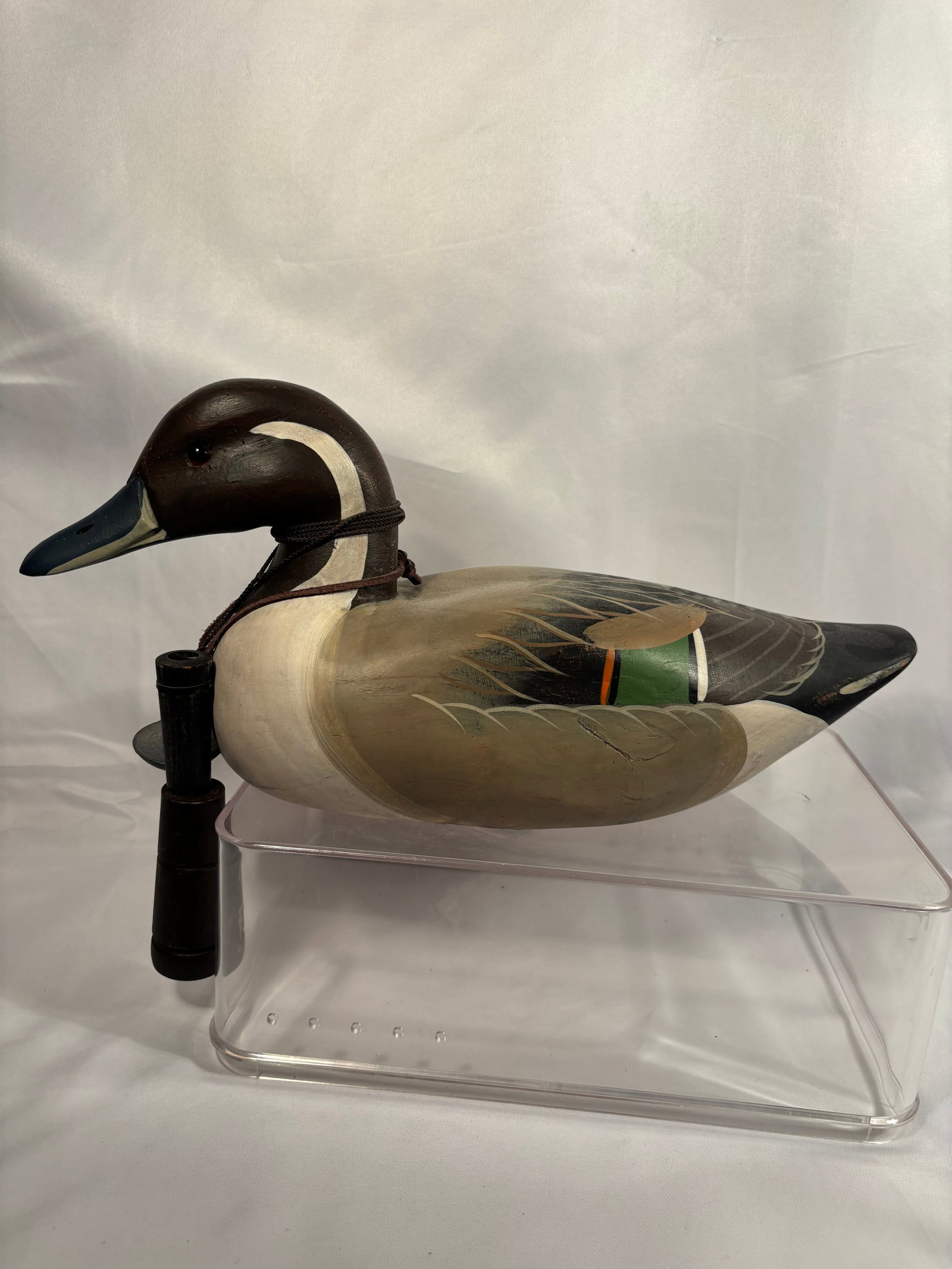 Vintage Painted Wooden Mallard Duck Decoy with Duck Call: A vintage carved and hand-painted wooden mallard drake decoy featuring a dark green head, contrasting neck band, painted feather details, and colorful wing accents. Accompanied by a two-piece wooden d