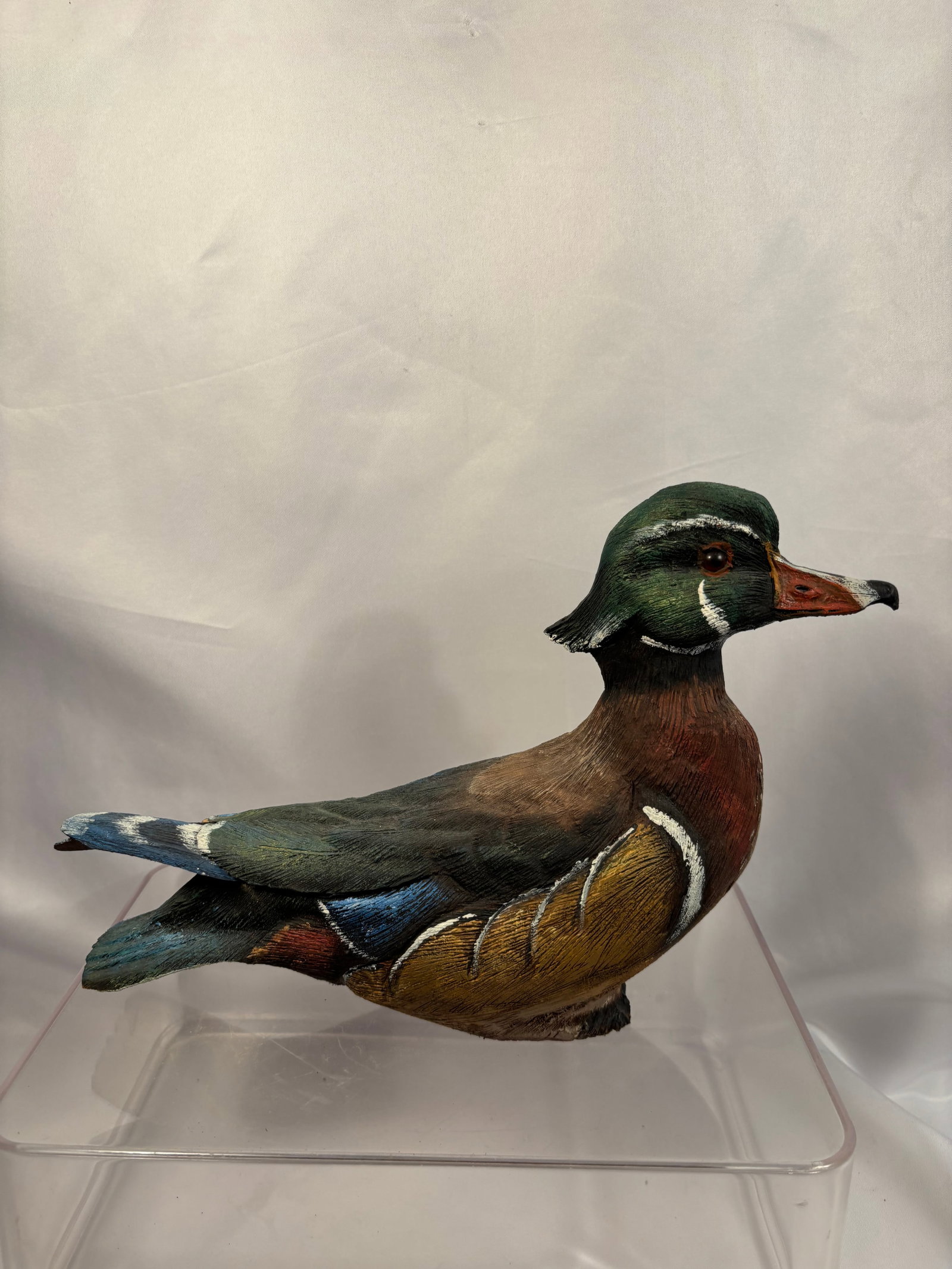 Charles Burns Signed Hand-Carved and Painted Wood Duck Decoy, Dated 2000 Signed C. Burns.: A hand-carved and hand-painted wooden decoy depicting a male wood duck, featuring finely incised feather details and rich green, reddish-brown, blue, and golden coloration. Signed and dated 2000 on th
