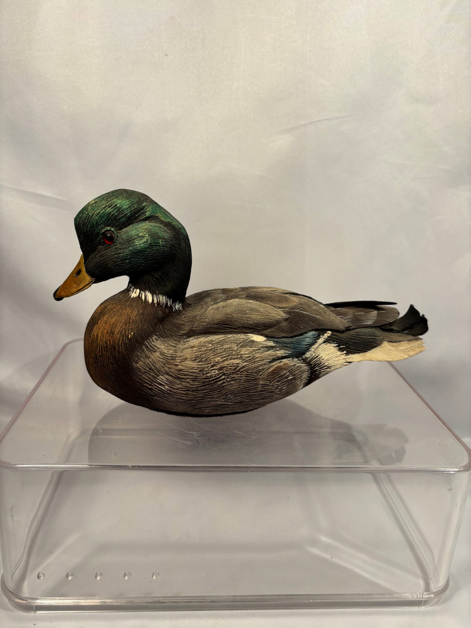 Charles “Charlie?? Burns Signed Hand-Carved Mallard Drake, 1997: A finely detailed, hand-carved and hand-painted wooden sculpture by Charles “Charlie” Burns, depicting a male mallard duck in a resting position. The carving features an iridescent green head,