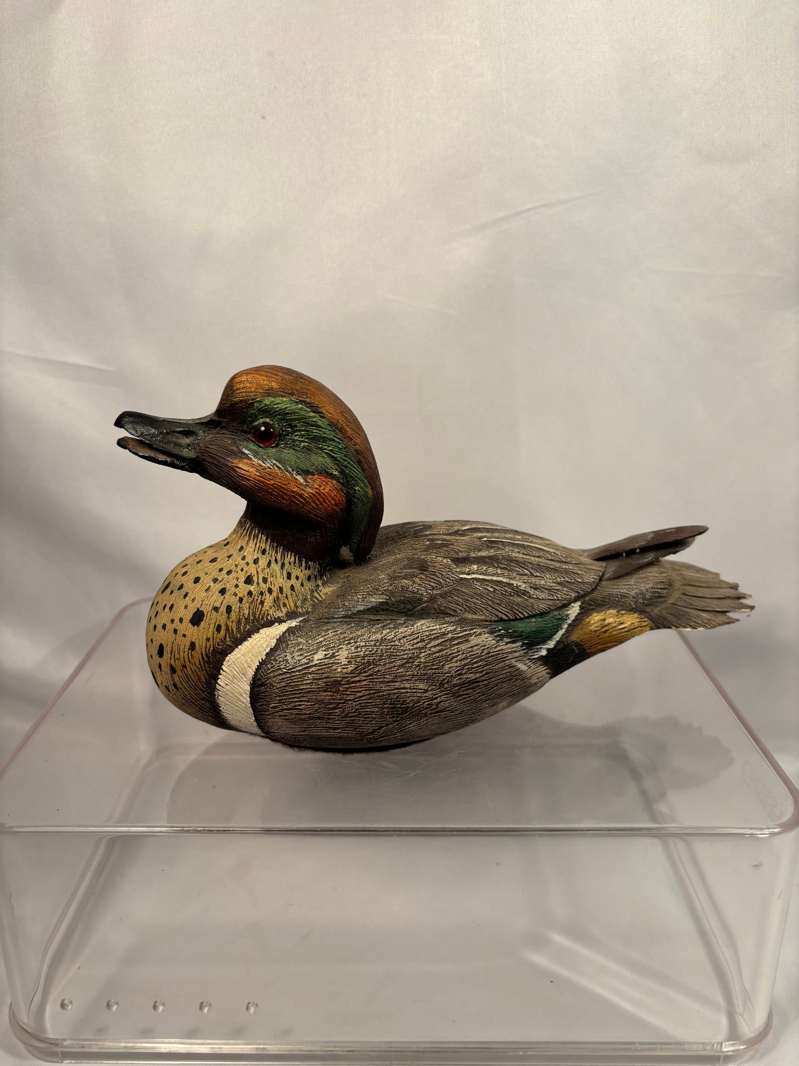 Charles “Charlie?? Burns Signed Hand-Carved Green-Winged Teal Drake, 1998: A finely detailed, hand-carved and hand-painted wooden sculpture by Charles “Charlie” Burns, depicting a male green-winged teal with its bill slightly open. The carving features a chestnut-bro