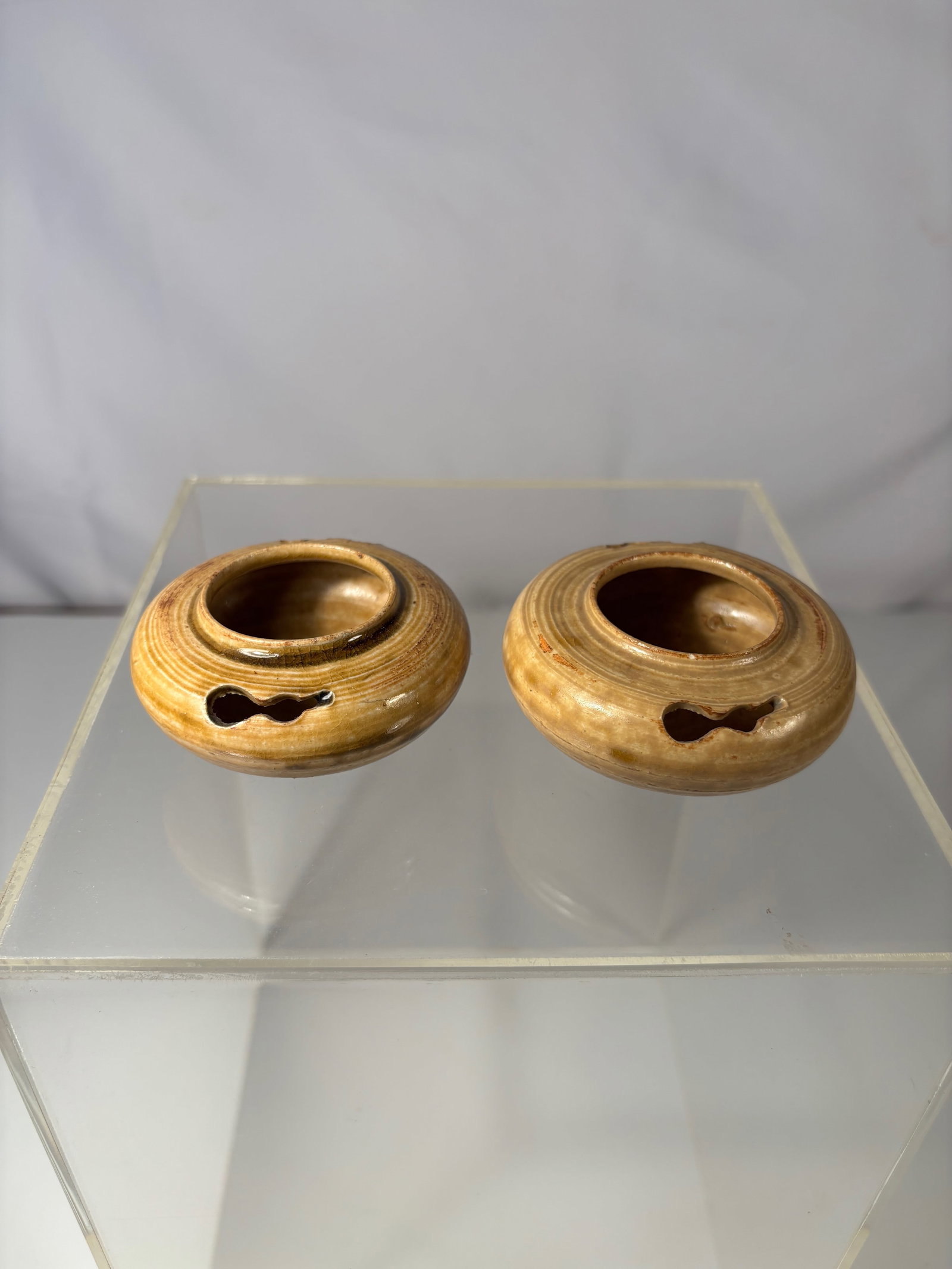 A Pair of Chinese Cizhou-Type Glazed Water Droppers: Qing Dynasty (1644-1912);A pair of small Chinese Cizhou-type stoneware water droppers, each of compressed globular form with circular banded decoration, the amber-brown glaze thinning at the rims and 