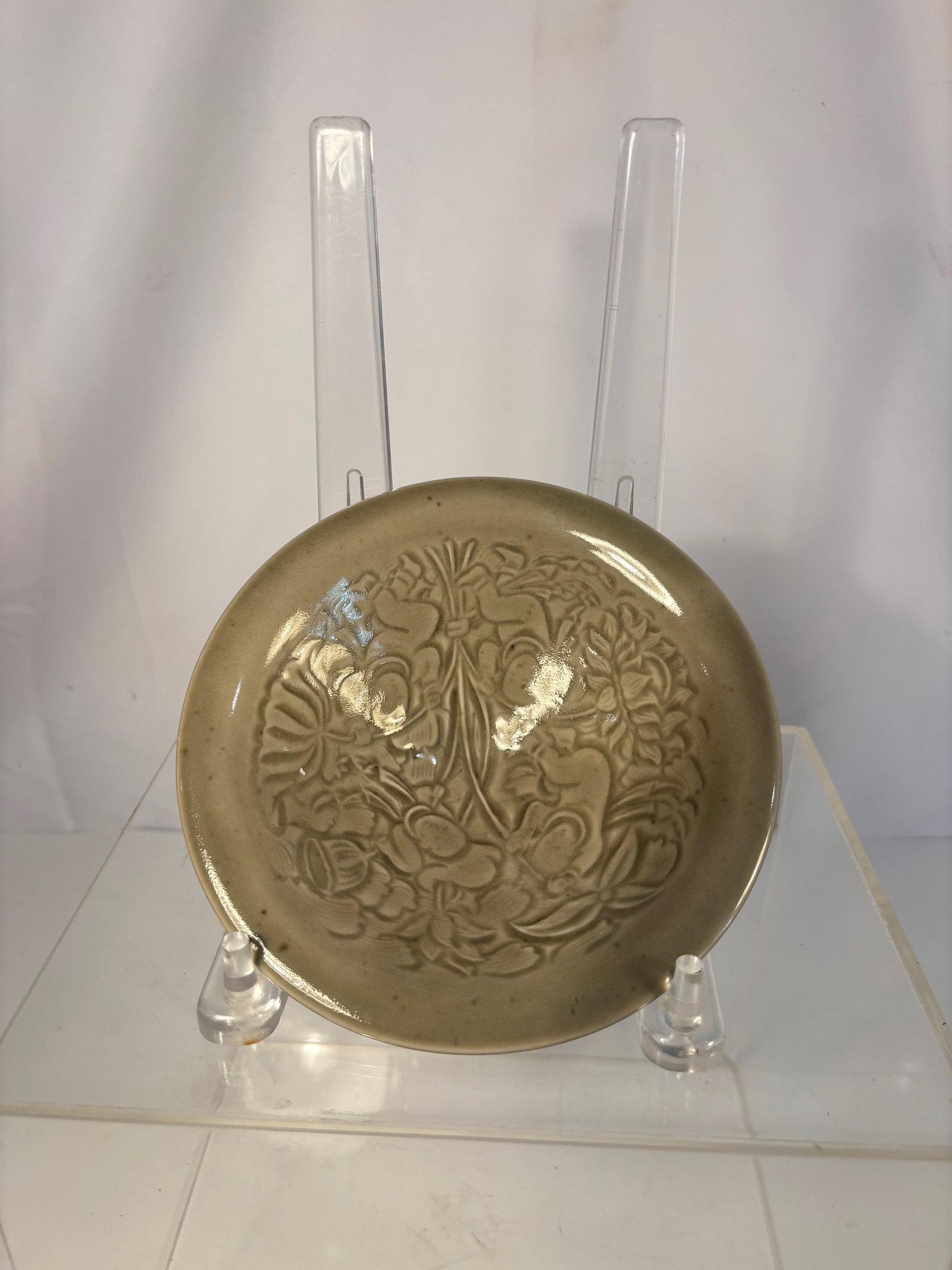 A Chinese Celadon Dish with Incised Floral Design, Yue-Type Ware,: Qing dyansty(1644-1912); A well-potted Chinese celadon dish, the shallow rounded sides rising to a gently everted rim, the interior finely incised with a central lotus blossom surrounded by scrolling 