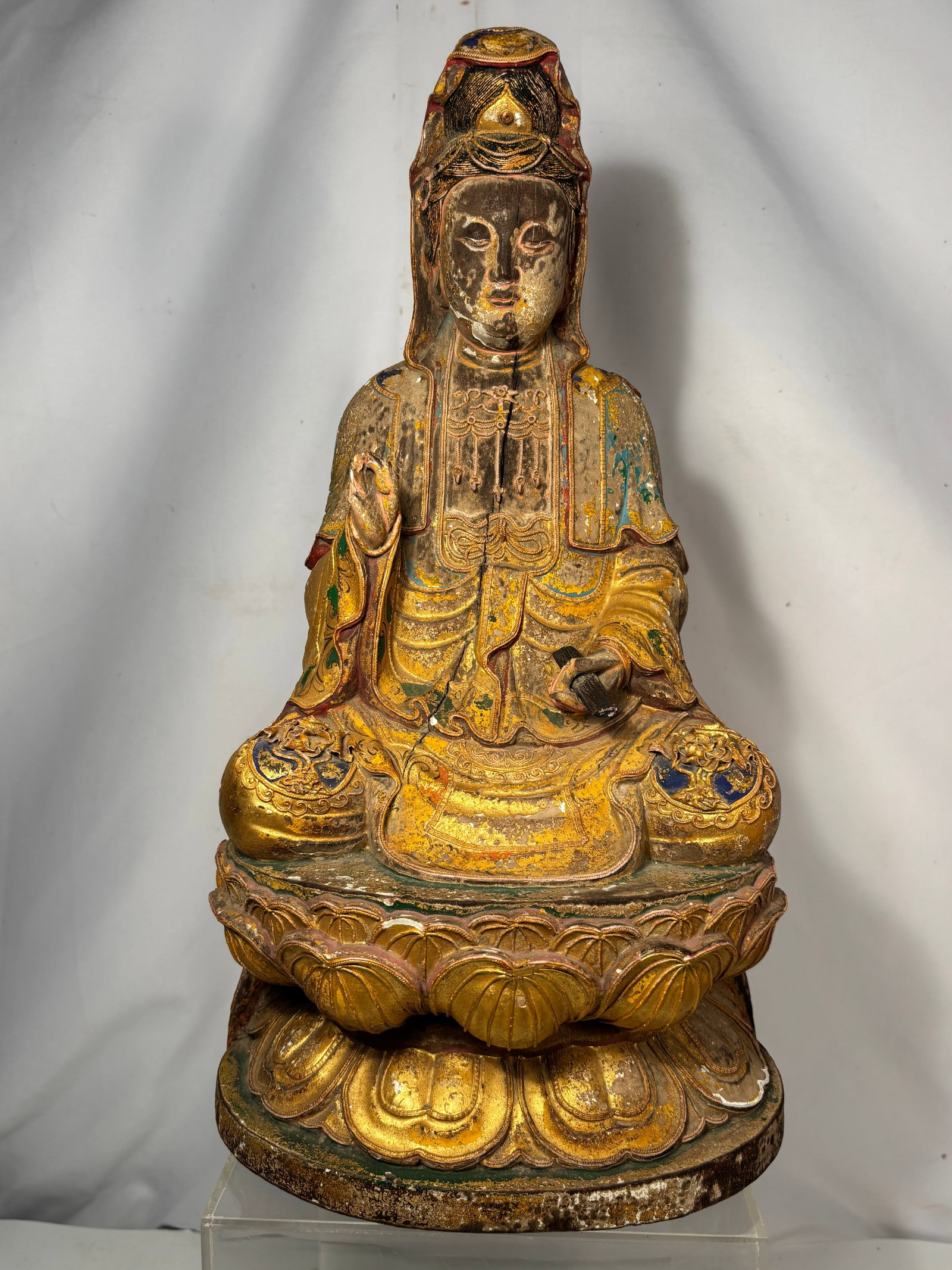 Antique Chinese Gilt & Polychrome Carved Wood Guanyin Bodhisattva Figure on Lotus Base: Qing Dynasty(1644-1912) ; An antique Chinese carved wood figure of Guanyin, the Bodhisattva of Compassion, depicted seated in a serene pose upon a finely carved double-lotus pedestal. The figure is ri