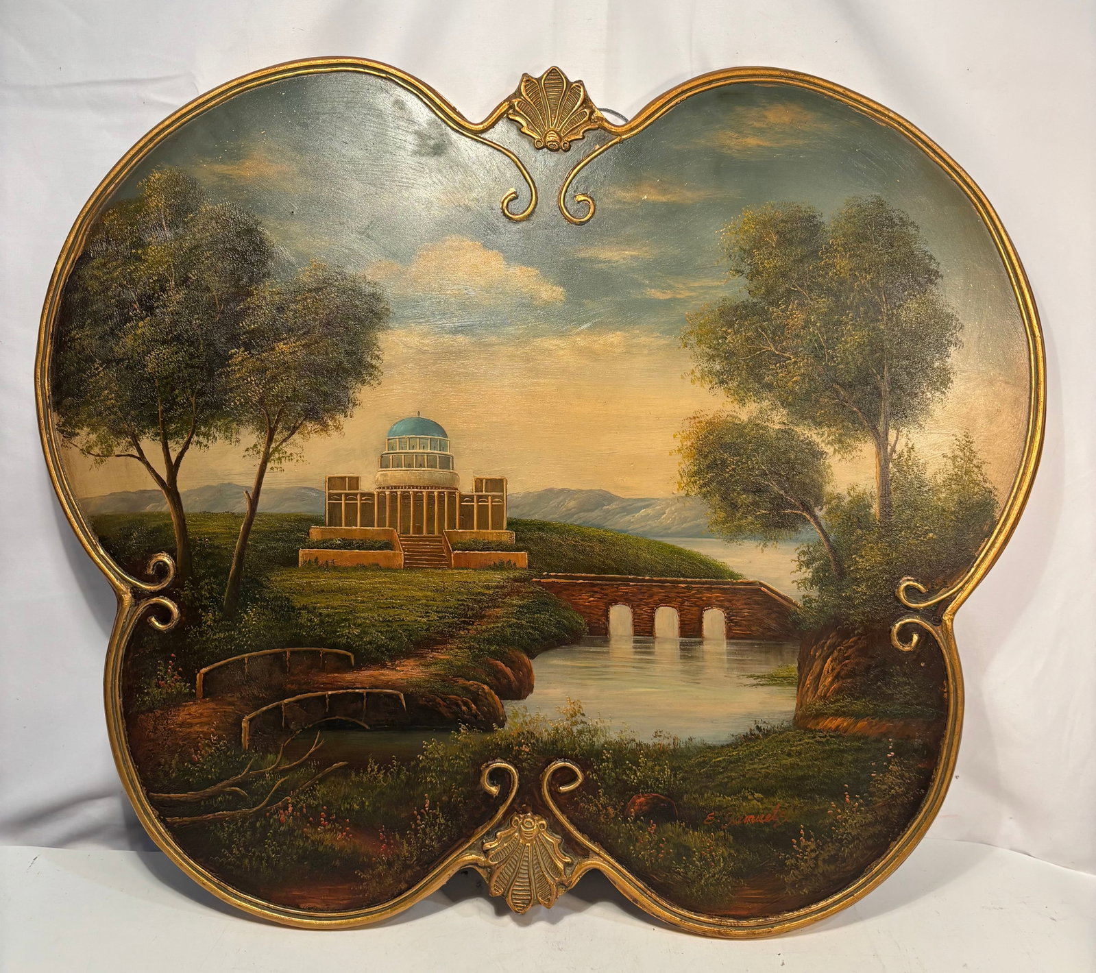 Vintage European Landscape with Neoclassical Domed Pavilion, Oil on Shaped Panel with Gilt: A decorative European landscape oil painting on a shaped wood panel, depicting a neoclassical domed pavilion overlooking a tranquil river with an arched stone bridge, mature trees, distant mountains, 