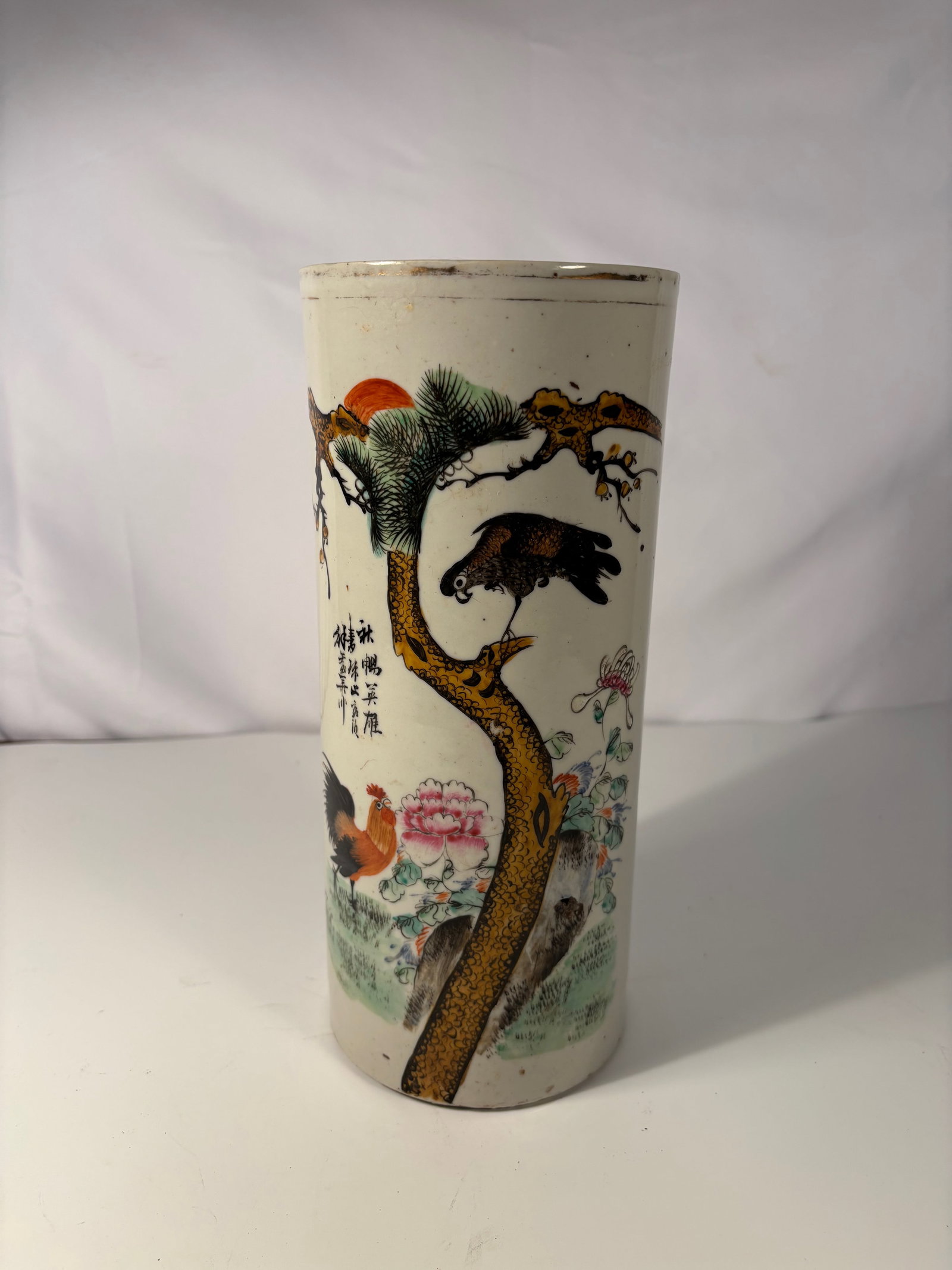 A Chinese Famille Rose Porcelain hat vase: Early 20th century (Republic period) ; Chinese famille rose porcelain hat vase, finely painted in bright enamels with a rooster beneath a gnarled pine tree, accompanied by large pink peonies and ornam