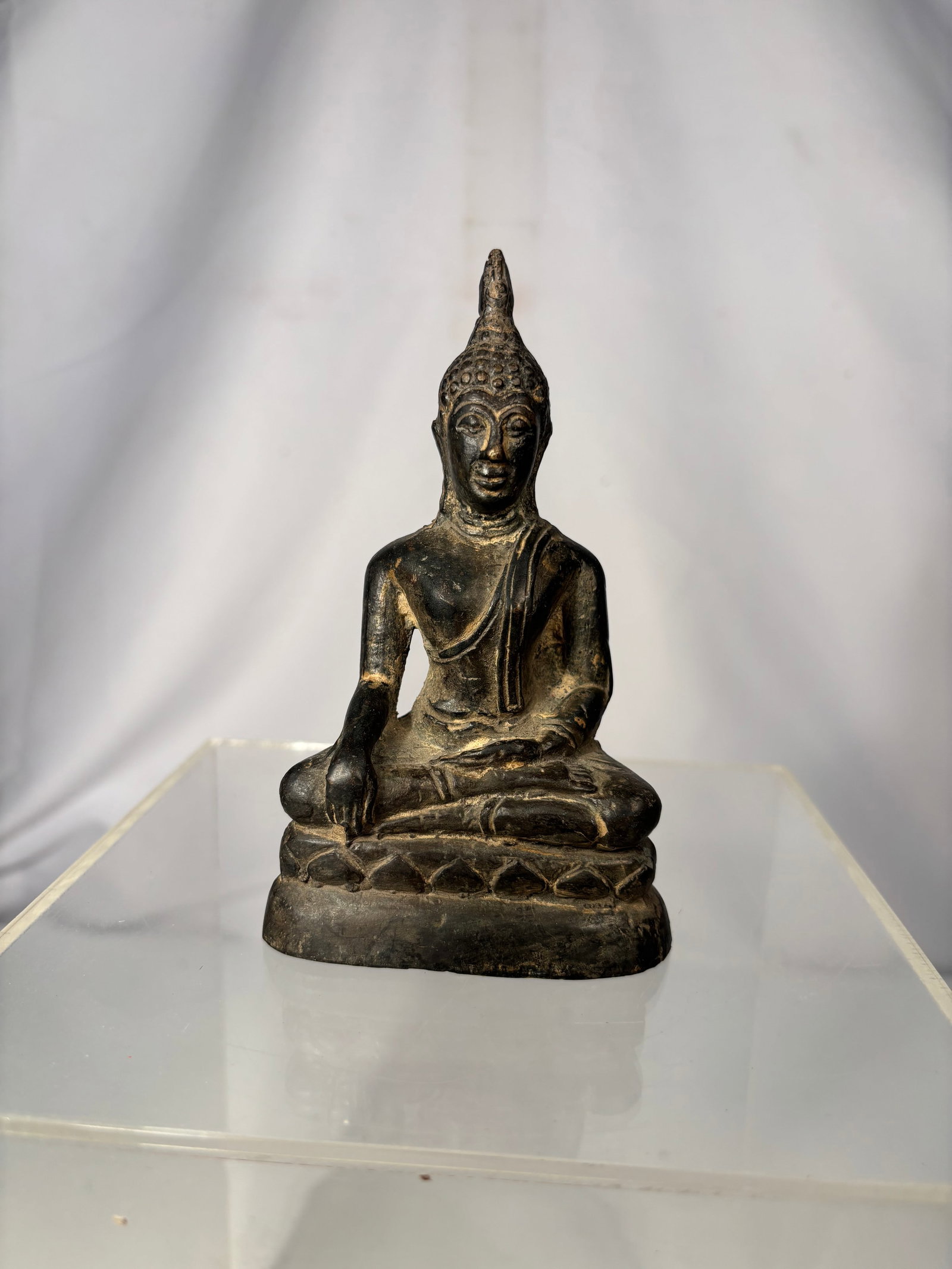 Antique Thai Bronze Seated Buddha Figure on Lotus Base , 19th century: Antique Thai bronze figure depicting the Buddha seated in the Bhumisparsha (Earth-Touching) Mudra, symbolizing the moment of enlightenment. The figure is seated cross-legged atop a lotus pedestal, wea