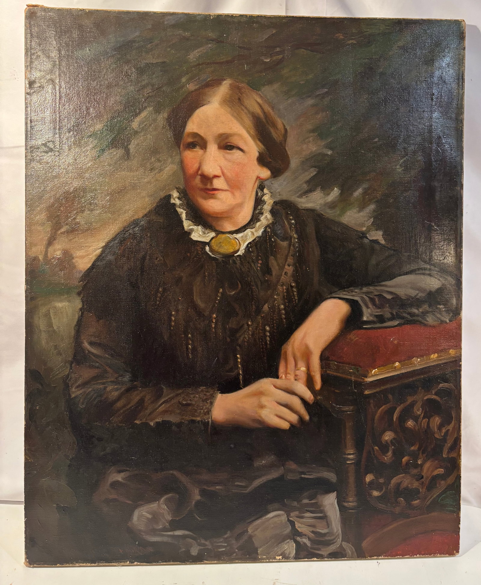 19th Century American School Portrait of a Lady, Possibly Mrs. G. B. Frost, Oil on Canvas: A 19th-century American School oil-on-canvas portrait depicting a mature woman seated in a three-quarter-length pose. The sitter wears a black Victorian dress with a white lace-trimmed collar, an oval