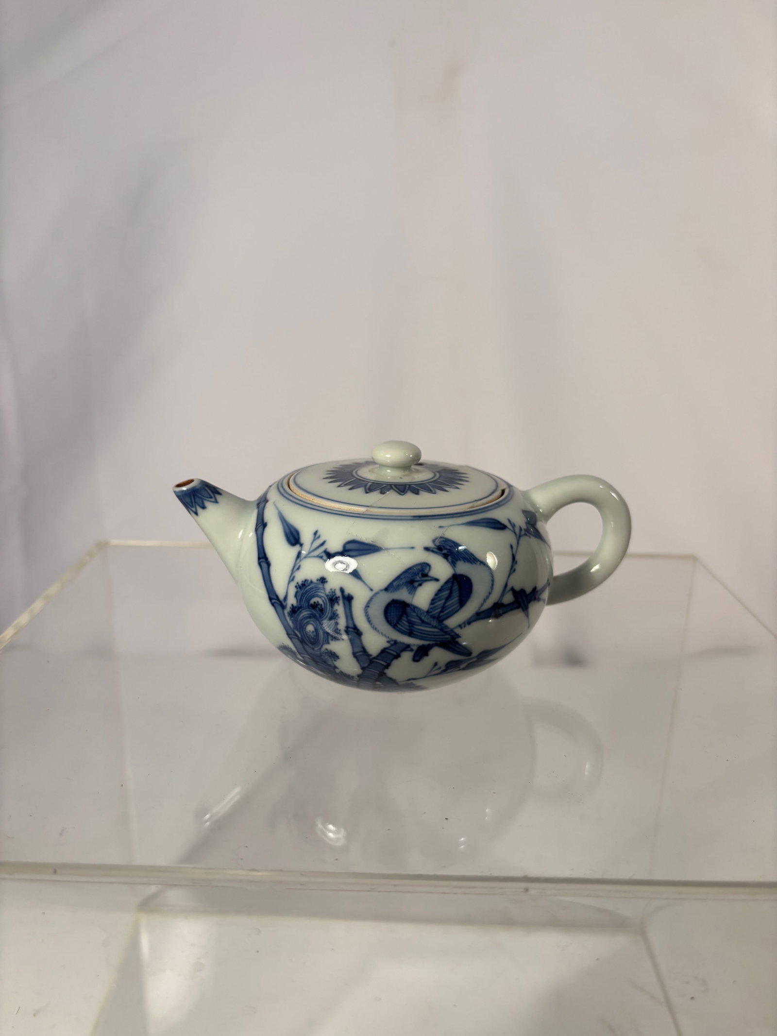 Japanese Blue and White Porcelain Teapot, “Rinshun?? (??) Mark, Arita Ware, Late Edo–Early: (c.1850–1880). A finely hand-painted Japanese blue and white porcelain teapot of rounded form with short spout and loop handle, surmounted by a domed lid with finial. Decorated in vivid underglaze