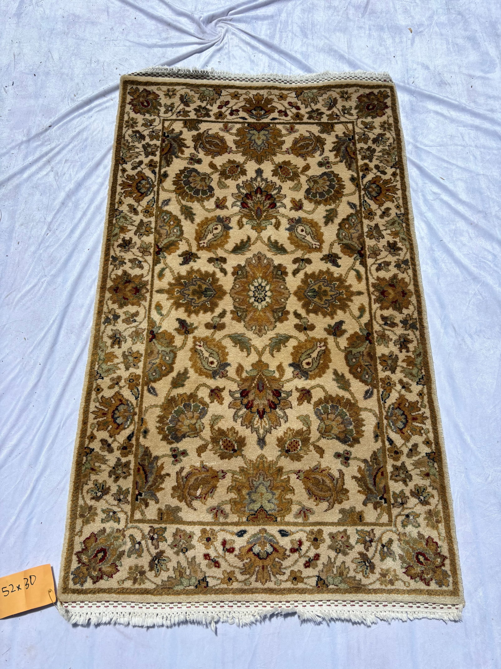 Hand-Knotted Persian Style Floral Rug 52 x 30 inches.: Hand-knotted wool rug with ivory field featuring floral and paisley motifs in soft earth-tone colors. Decorative multi-border design with central medallion elements and fringe ends. Fine detailed weav