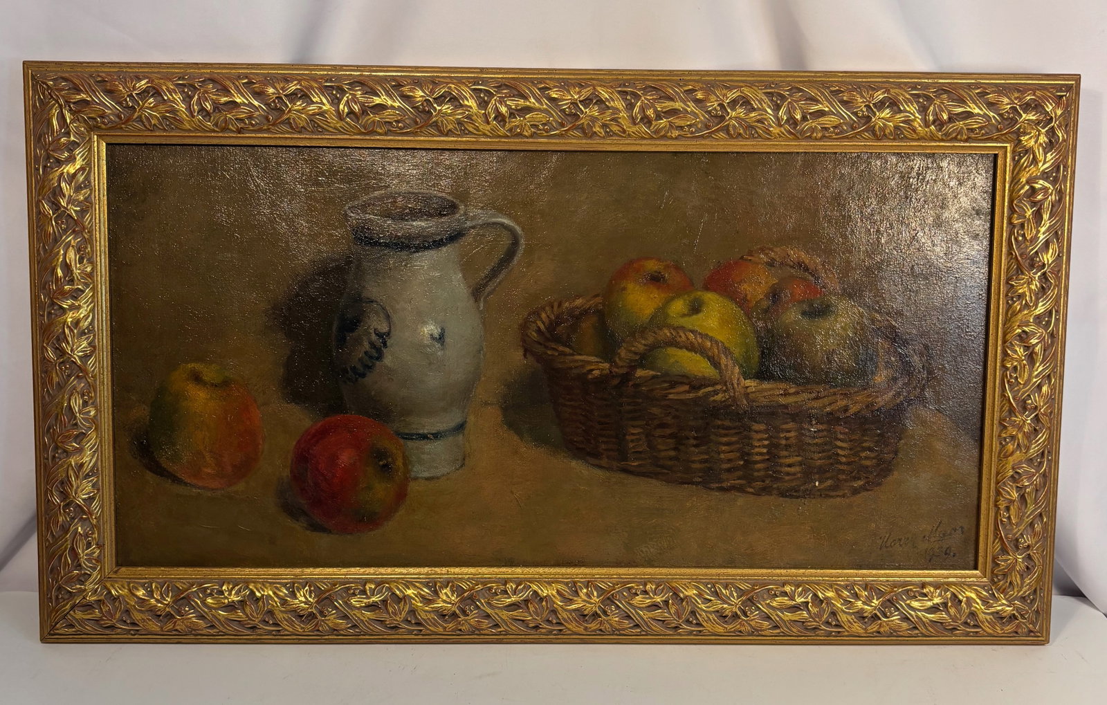 European School (Signed & dated 1930s ) Still Life with Basket of Apples and Ceramic Pitcher , oil: A finely rendered still life depicting a wicker basket filled with apples, accompanied by a ceramic pitcher and two loose fruits arranged on a tabletop. The artist employs a warm, harmonious palette o