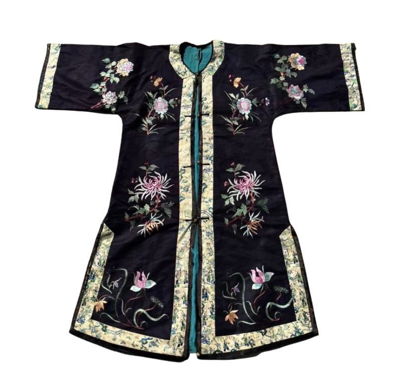 A Chinese Embroidered Silk Robe with Floral Decoration: Qing Dynasty(1644-1912), A dark indigo silk robe finely embroidered in polychrome silk threads with sprays of chrysanthemums, peonies, and lotus blossoms, symbols of longevity, prosperity, and purity.