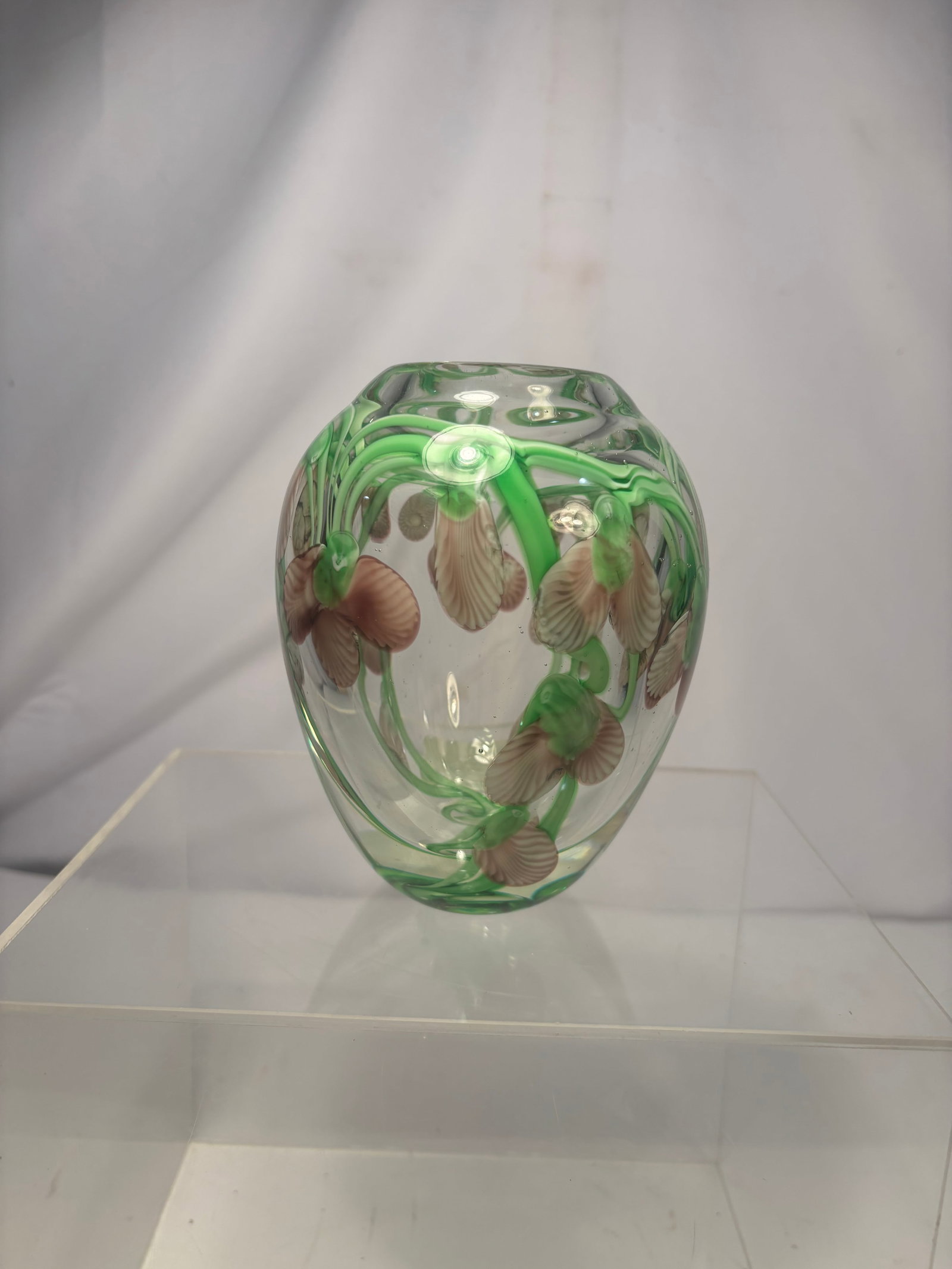 Vintage Murano-Style Applied Floral Art Glass Miniature Vase: A vintage handblown art glass miniature vase featuring a thick, clear glass body decorated with colorful applied floral motifs in shades of green, pink, cream, and brown. The vase has a rounded organi