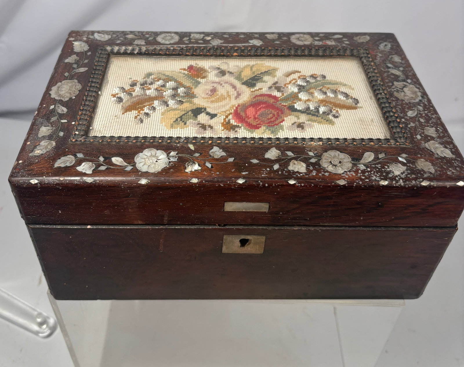 Antique Victorian Mother-of-Pearl Inlaid Rosewood Sewing Box with Floral Needlepoint Top: An antique Victorian rosewood sewing or jewelry box of rectangular form, featuring a floral needlepoint panel inset into the hinged lid. The exterior is richly decorated with mother-of-pearl floral an
