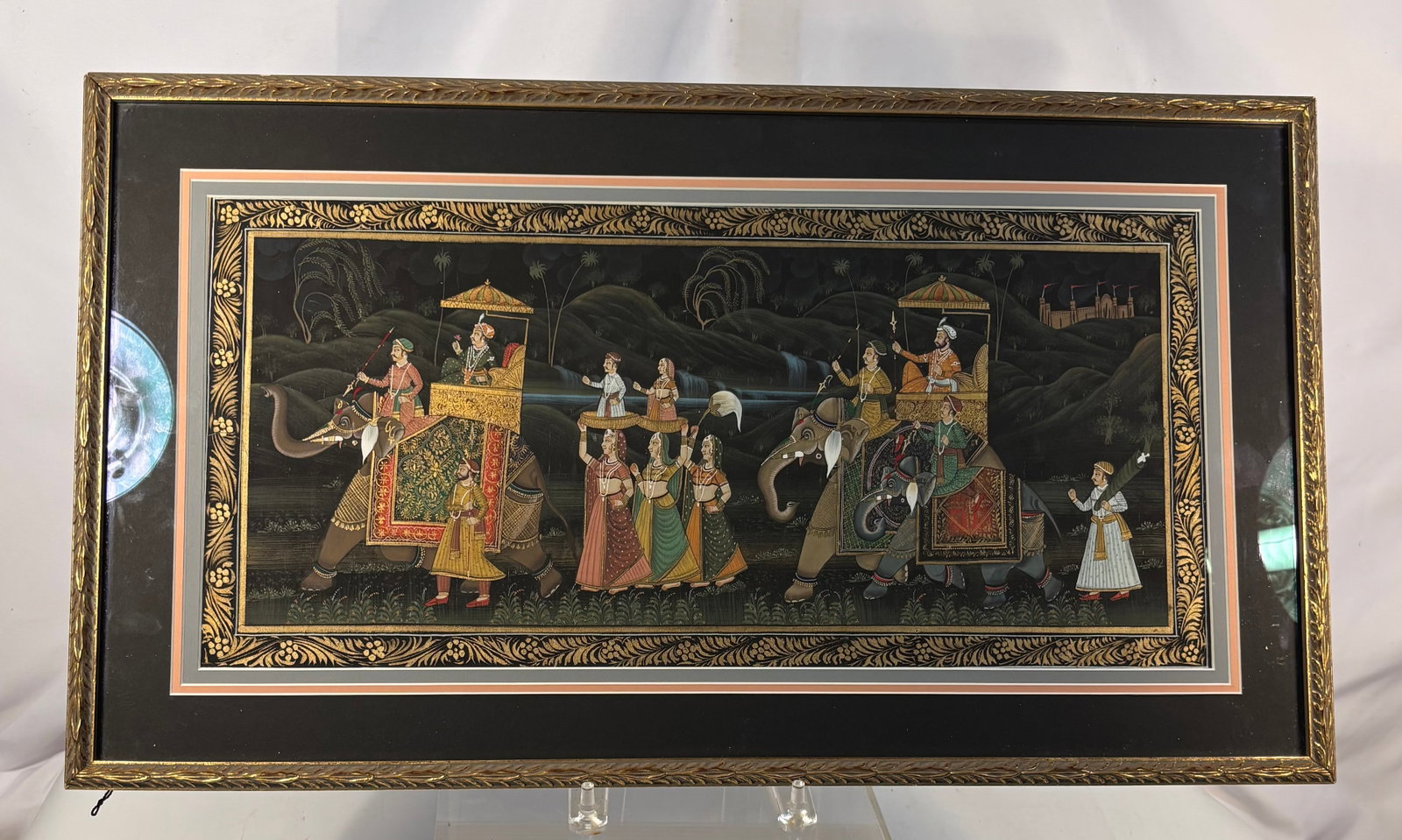 Indian Mughal-Style Royal Elephant Procession Painting, Framed: A finely detailed vintage Indian painting depicting an elaborate royal procession. Two richly caparisoned elephants carry rulers beneath ceremonial parasols, accompanied by attendants, noblewomen and 