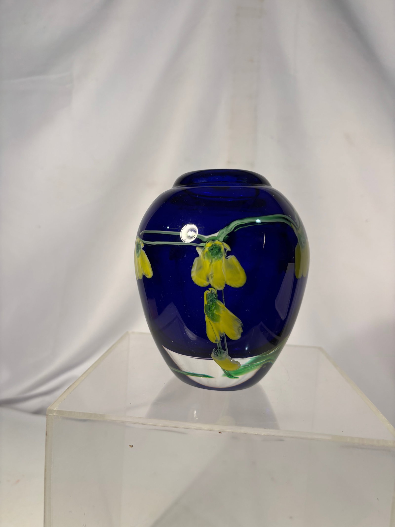 Cobalt Blue Art Glass Vase with Hand-Painted Yellow Bellflowers, Enameled Floral Decoration: A rich cobalt blue art glass vase of ovoid/egg-shaped form, tapering to a short cylindrical neck. The body is hand-decorated with a trailing motif of pendant, bell-shaped yellow flowers in cluster gro