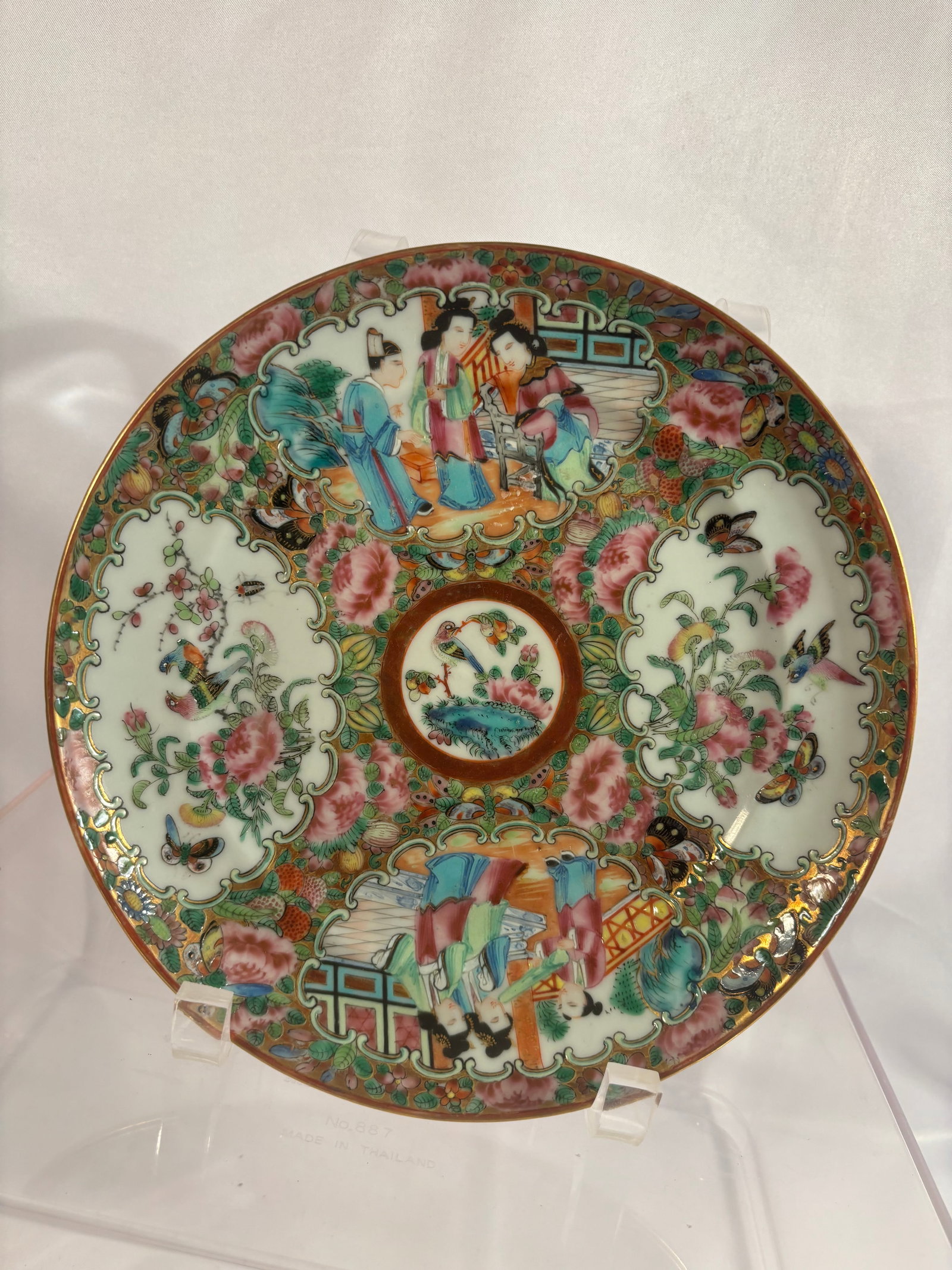 A Chinese Export Rose Medallion Porcelain Plate, 19th Century: A Chinese export porcelain plate finely decorated in the Rose Medallion palette. The interior features alternating shaped reserves depicting court figures in domestic settings and birds, butterflies, 
