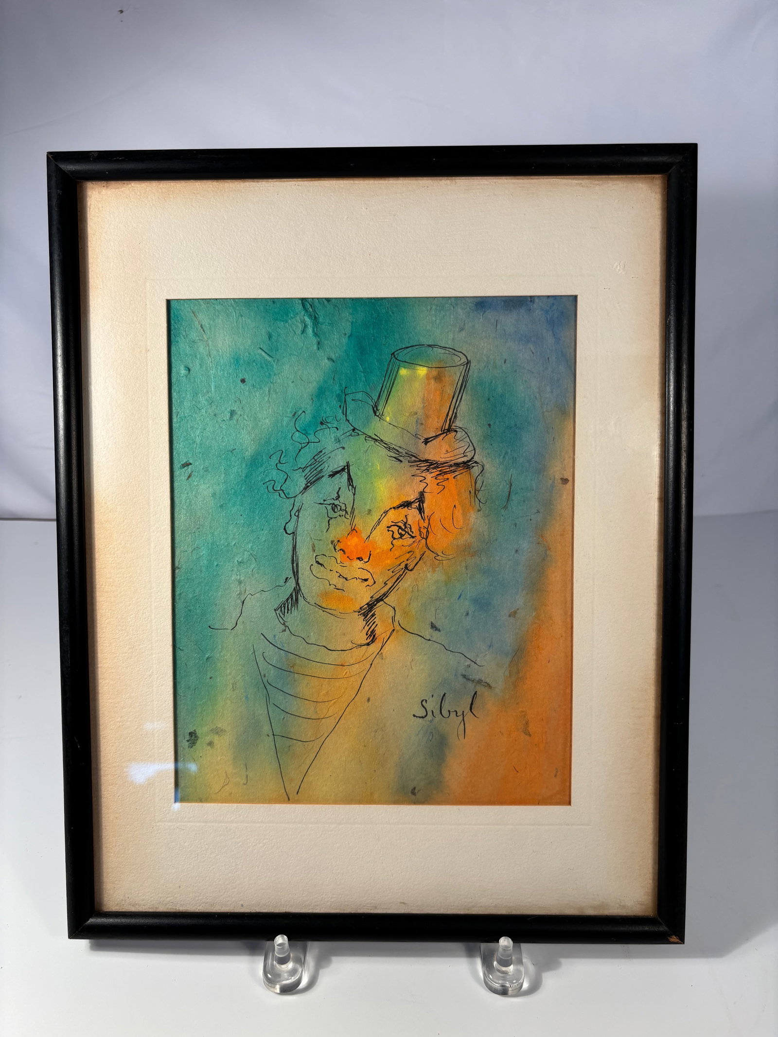 “Clown?? Watercolor and Ink on Paper signed "Sibyl": Whimsical watercolor and ink portrait of a clown in a top hat, executed in loose linear drawing over vibrant washes of teal, orange, and yellow. Signed lower right Sibyl. Sibyl Hechtenthal was known