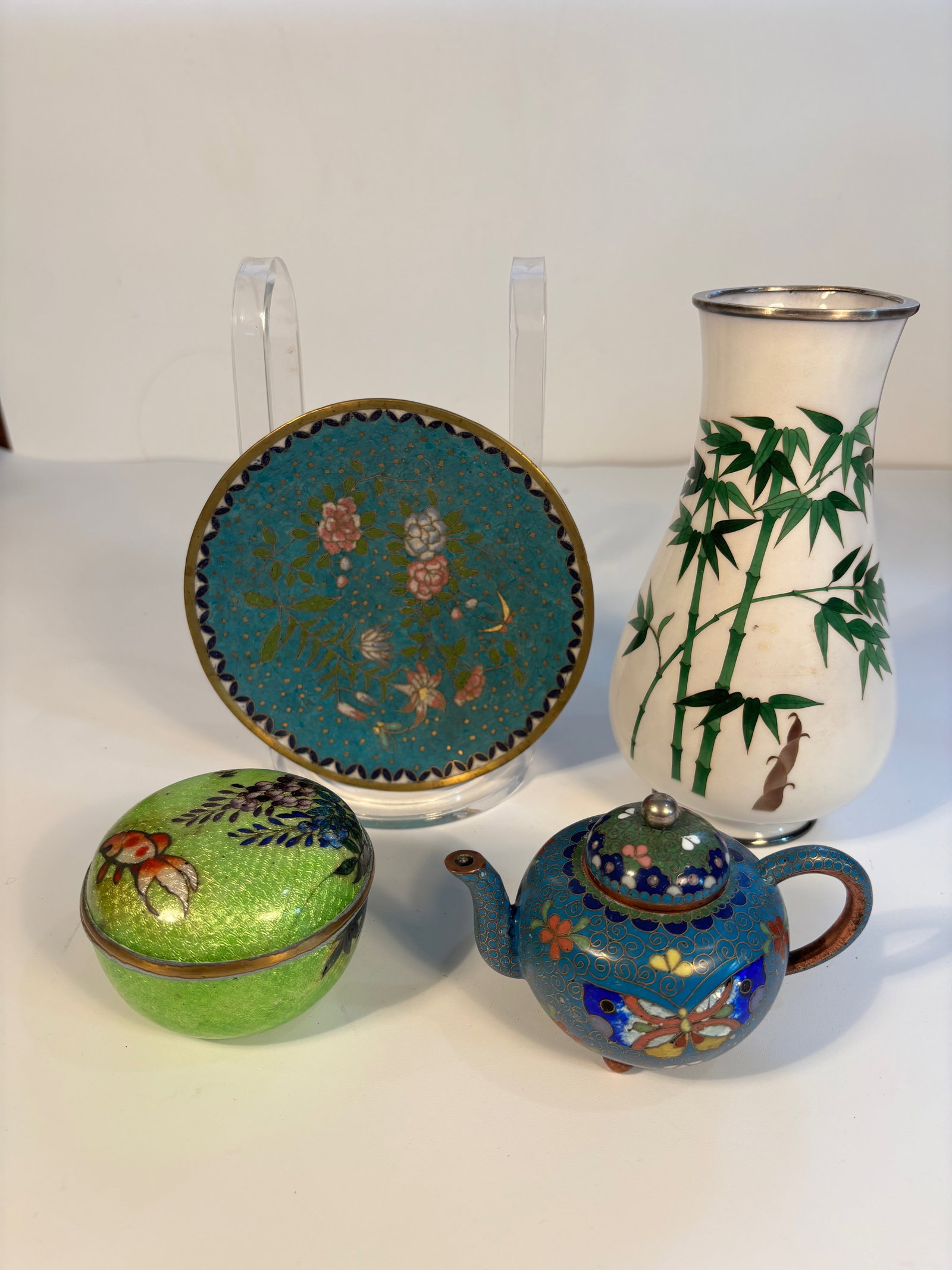 Set of four Asian cloisonné enamel pieces: 19th century; This set including a cloisonné plate; enamel bamboo design vase; a cloisonné teapot and a enamel box. Dimensions?Height of the highest piece : 7 1/4 inches