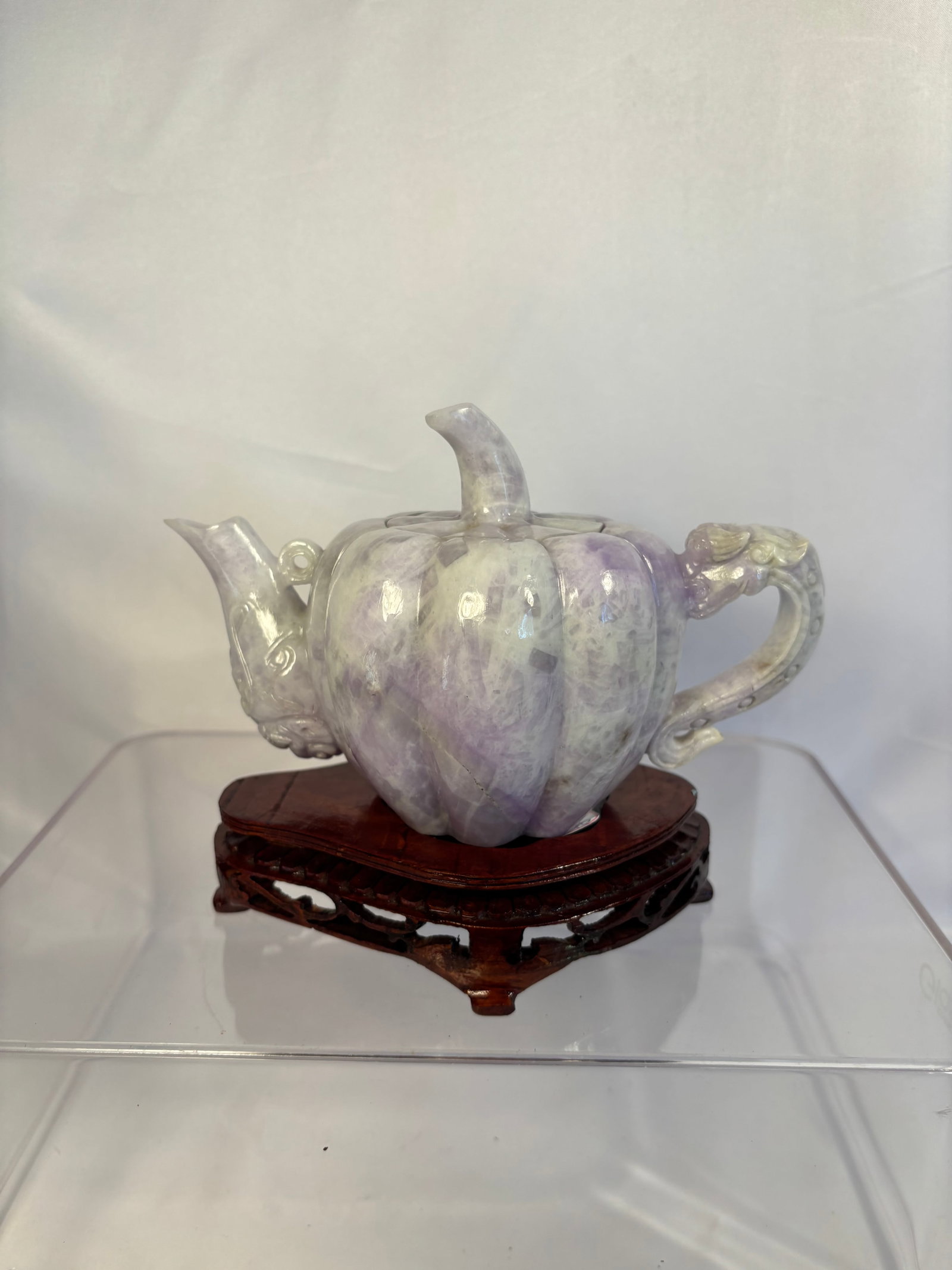 Chinese Carved Purple Jadeite Pumpkin-Form Teapot: A Chinese carved purple jadeite teapot finely modeled in a lobed pumpkin form. The stone displays attractive variegated lavender-purple, pale green and creamy-white tones with areas of translucency. T