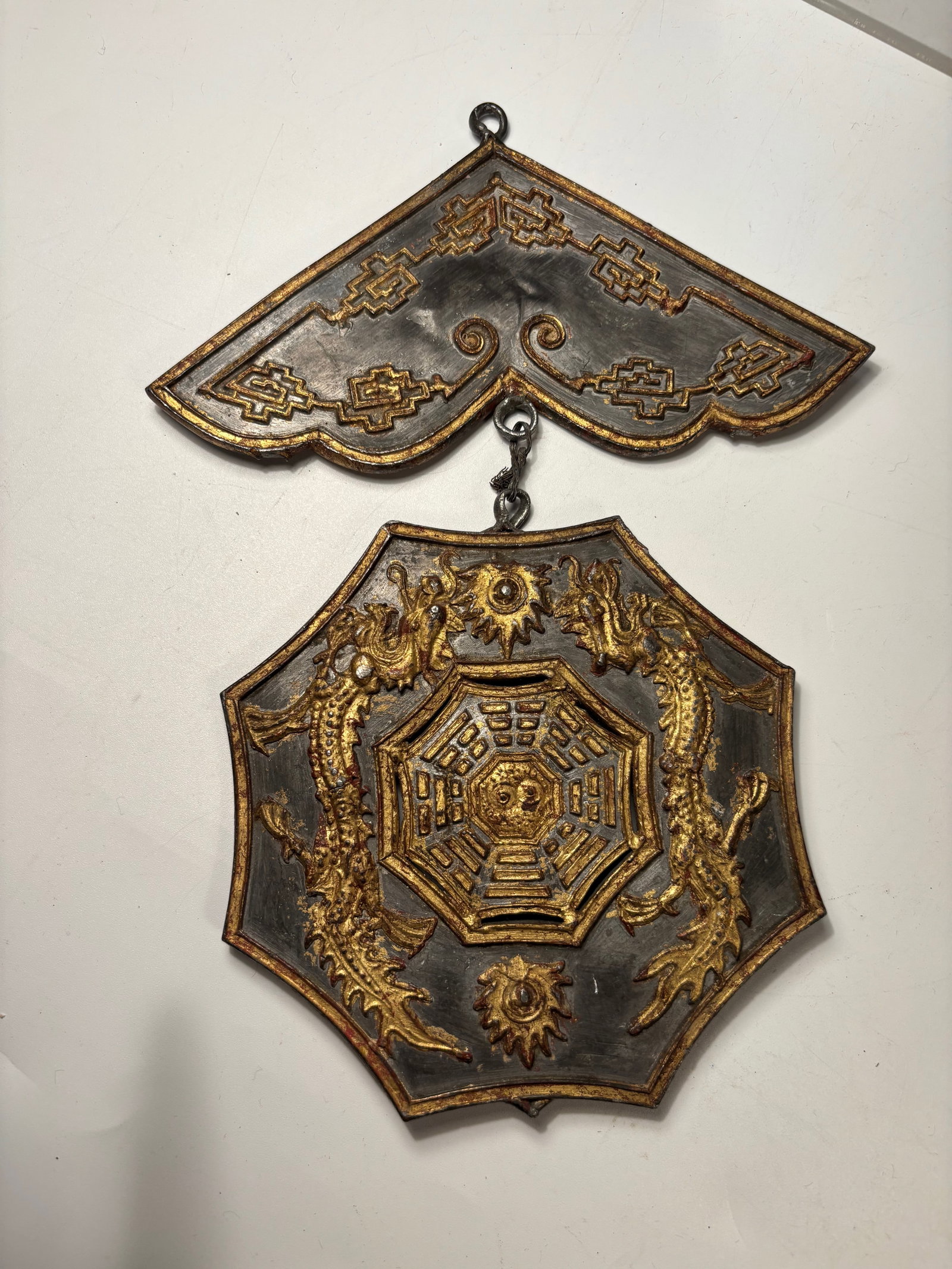 A Chinese Gilt Pewter Double Dragon Bagua Pendant: Chinese gilt pewter hanging ornament composed of two connected plaques. The lower plaque features a central Bagua (Eight Trigrams) motif with yin-yang symbol, flanked by two dragons in relief. The upp