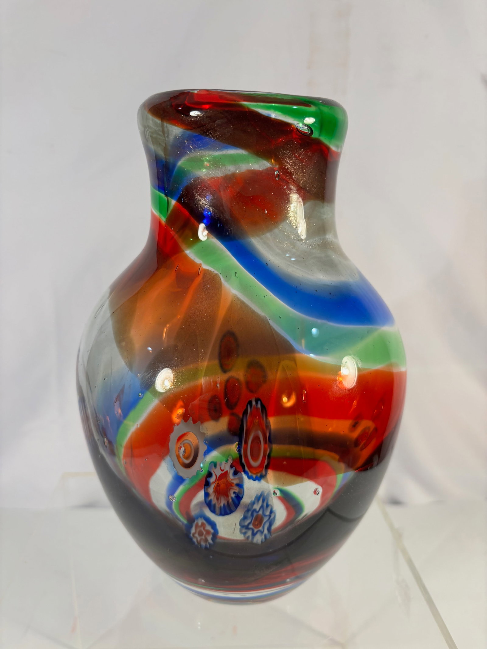 Murano Style Millefiori Art Glass Vase Mid Century: Mid-century art glass vase decorated with millefiori canes and multicolored glass ribbons. Freeform organic shape with clear casing over colorful inclusions. Height: 10 inches.