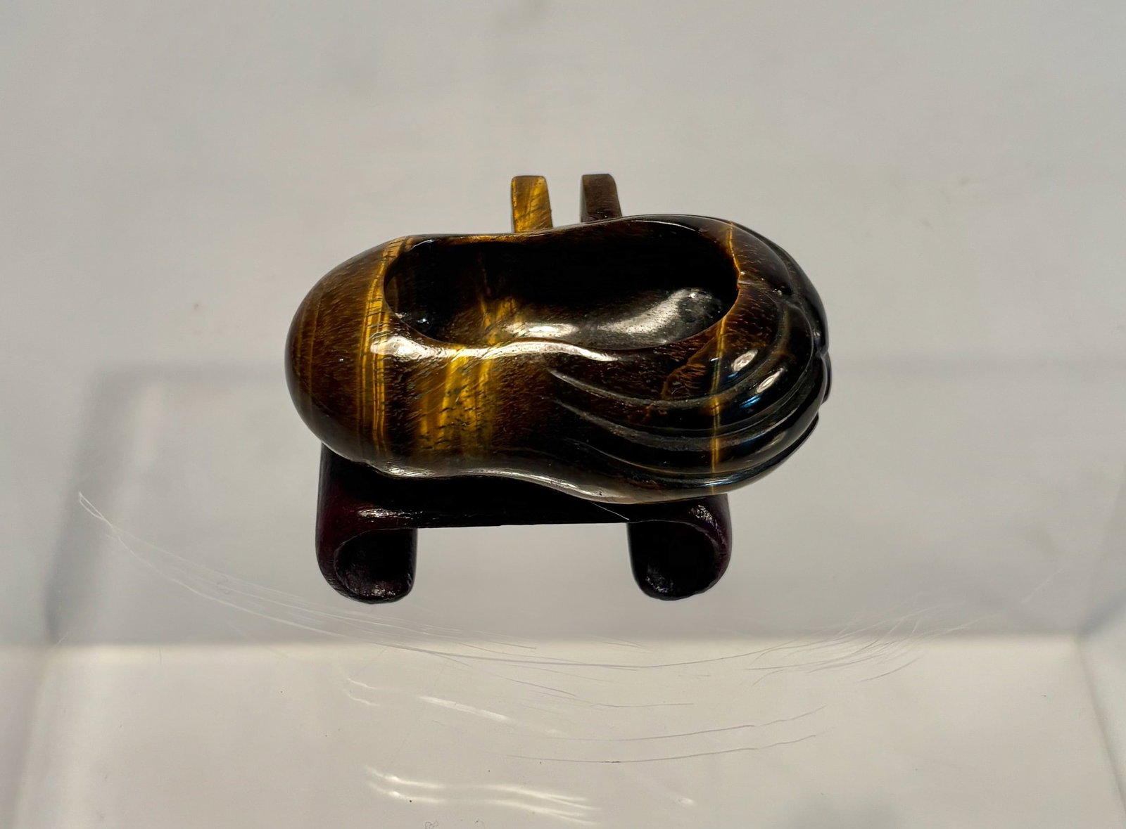 A Carved Tiger’s Eye Bird Feed Cup, Miniature Feeder: A finely carved tiger’s eye bird feed cup, traditionally used as a food or water holder for small songbirds. Fashioned from richly banded tiger’s eye stone, the piece displays beautiful natural ch
