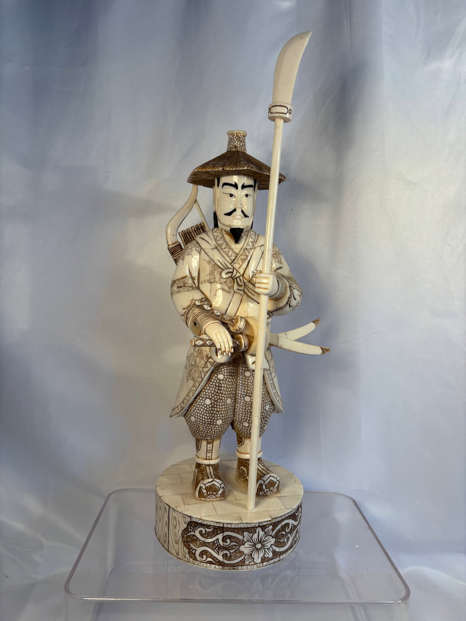 Large Japanese Carved Bone Samurai Warrior Figure on Floral Base. Signed Gyokushi , 18 in.: A large carved bone figure depicting a standing Japanese samurai warrior dressed in elaborately decorated armor and holding a long weapon. Constructed from multiple fitted bone sections with finely en