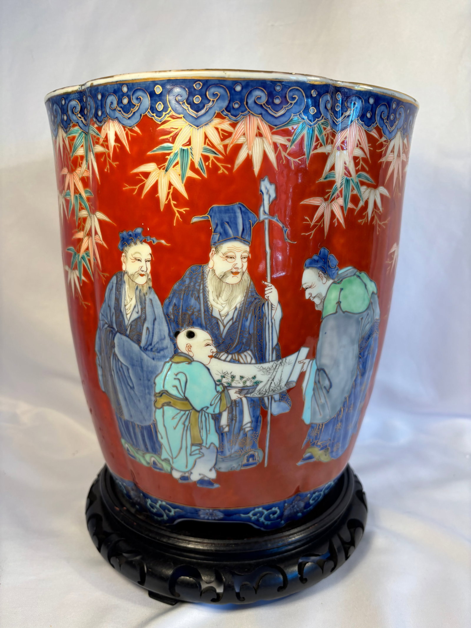 Antique Japanese Fukagawa Porcelain Red-Ground Jardinière with Scholars, Meiji–Taish? Period,: An impressive early-20th-century Japanese porcelain jardinière by Fukagawa, of gently tapered form with a shaped, lobed rim. The exterior is richly decorated in polychrome enamels with Chinese-inspir