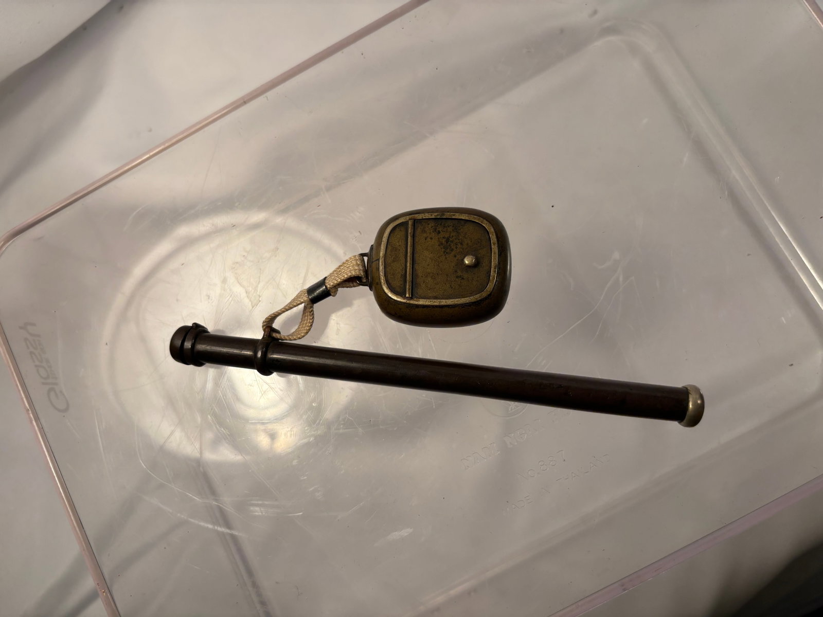 Japanese Meiji Period Yatate Portable Writing Set with Brass Inkwell: A Japanese yatate portable writing set dating to the Meiji period (1868–1912), comprising a long cylindrical brush holder attached by woven cord to a compact brass inkwell. The hinged inkwell opens 