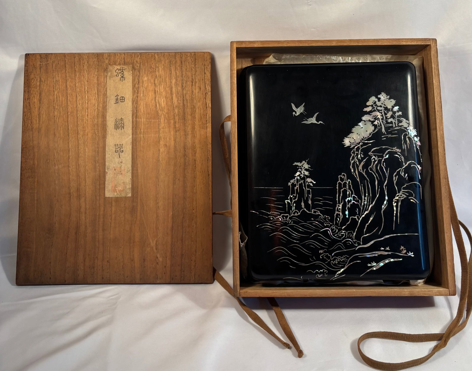 Japanese Raden Mother-of-Pearl Lacquer Suzuribako Writing Set with Chinese Huizhou Ink Sticks,: A Japanese black lacquer suzuribako writing box decorated in raden mother-of-pearl inlay with a dramatic coastal landscape of crashing waves, rocky cliffs, pine trees and flying cranes. The mother-of-