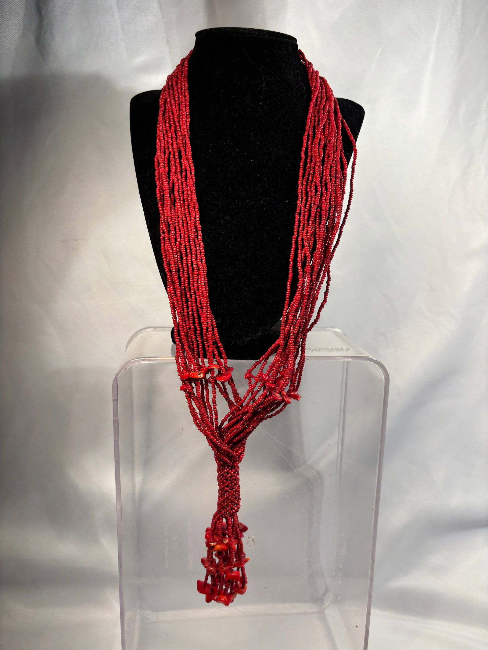 Large Multi-Strand Coral-Like Red Bead Necklace: A striking multi-strand statement necklace composed of numerous small coral-like red beads, accented with irregular branch-form and chip-form beads. Finished with a coordinating beaded toggle-style