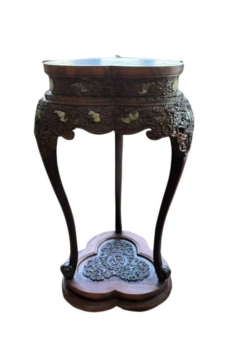 A Chinese hand carved rosewood/ zitan stand with jade inlay: Qing dynasty(1644-1912). An elaborately carved Chinese rosewood/ zitan wood stand, the pierced apron deeply carved in high relief with swirling ruyi clouds and bats amidst floral scrollwork. Inlaid th