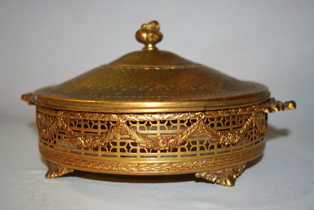 Apollo Studios Ormolu Vanity Dish Holder: Apollo Studios ormolu vanity dish holder – missing glass insert; likely produced between 1909 and 1922. Stamped “Apollo 3002/6 1/2” and inscribed p32693. Measurements: approximately 8 ½” wide