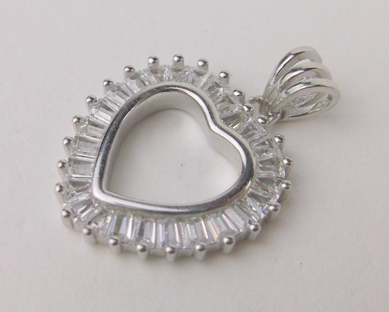 New Sterling Silver Heart Pendant: Solid Sterling Silver Guaranteed, in Brand New Never Worn Condition.