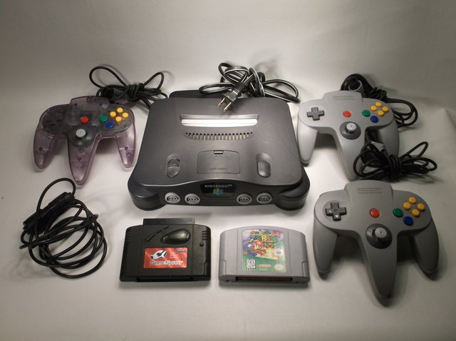 Nice Nintendo 64 Game System Console Bundle: Nice Bundle, works perfect, comes with Nintendo 64 console, power cord, all hookups, 3 genuine nintendo controllers, controller extension, Super Mario 64 game cartridge, and game shark cheat code cart