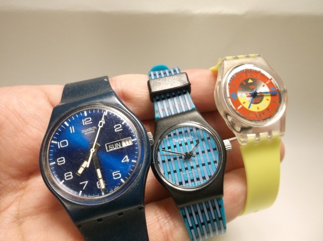 Swatch Watch & More Wristwatch Lot: 2 are swatch brand, one is le watch, 1 swatch needs batteries, one is working but needs a hook on the band, le watch needs a battery