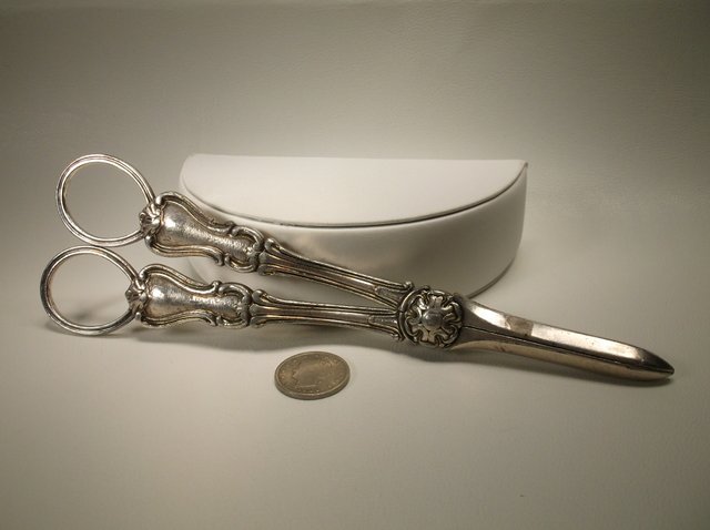 Super Heavy Antique Sterling Silver Ornate Scissors: very very thick, solid, and heavy. The entire handle section is solid sterling silver, the blades on the scissors are stainless steel, handles are very heavy by themselves
