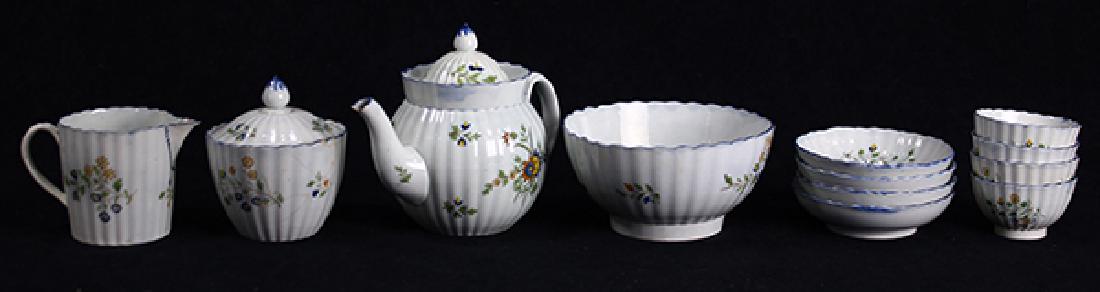 (Lot of 12) English Staffordshire pearlware partial: (Lot of 12) English Staffordshire pearlware partial table service circa 1780, each having a blue line rim, above a ribbed form body painted in ochre, blue, yellow, and green with scattered floral spra
