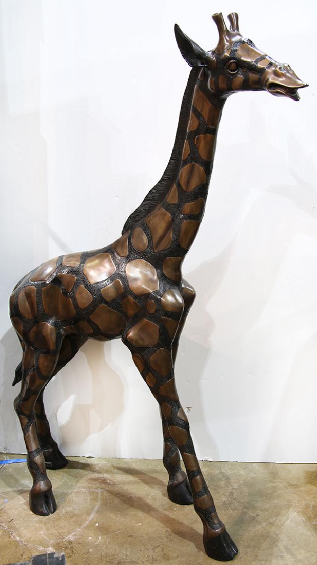 Patinated bronze giraffe sculpture, having a partial (1 of 1)