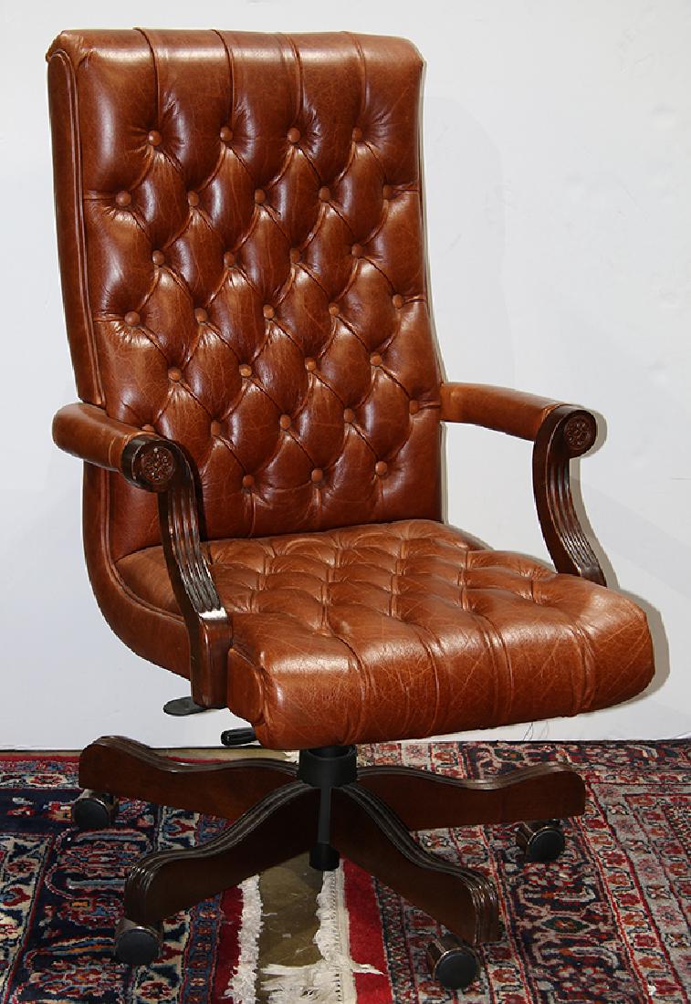 Leather office chair, having brown tufted upholstery: Leather office chair having brown tufted upholstery and rising on casters 43""h x 26""w x 26""d