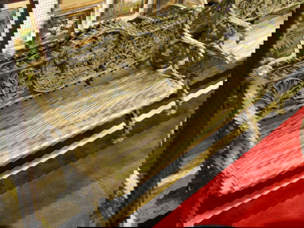 Cast iron railway bench: Cast iron and wood garden bench with a hunting dog medallion